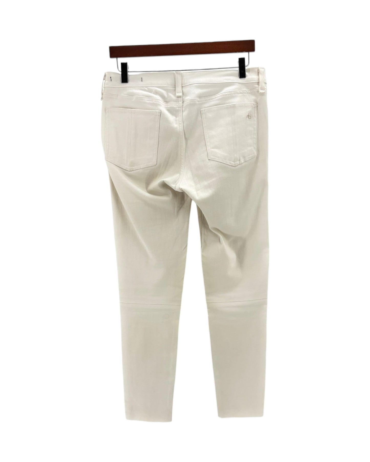 White pants on a hanger against a white background