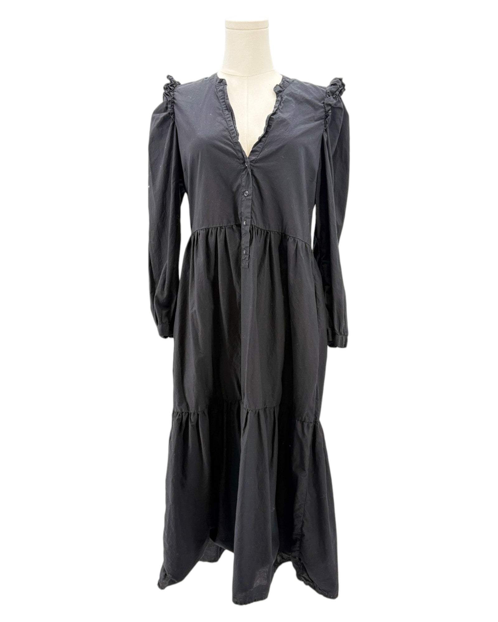nation LA black dress with ruffled shoulders on a mannequin against a white background