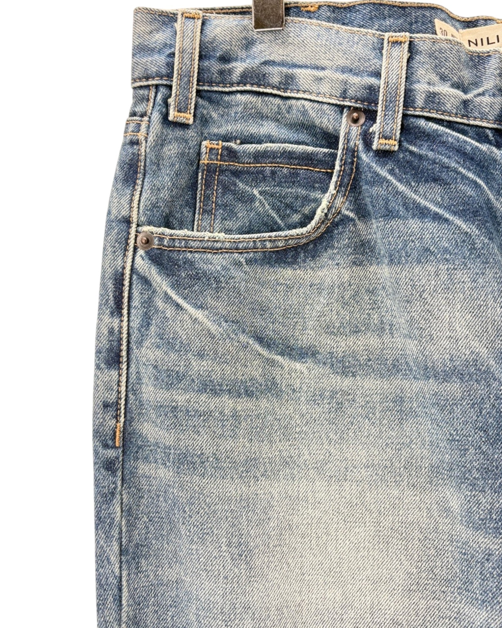 Close-up of a pair of blue jeans with a visible brand label.