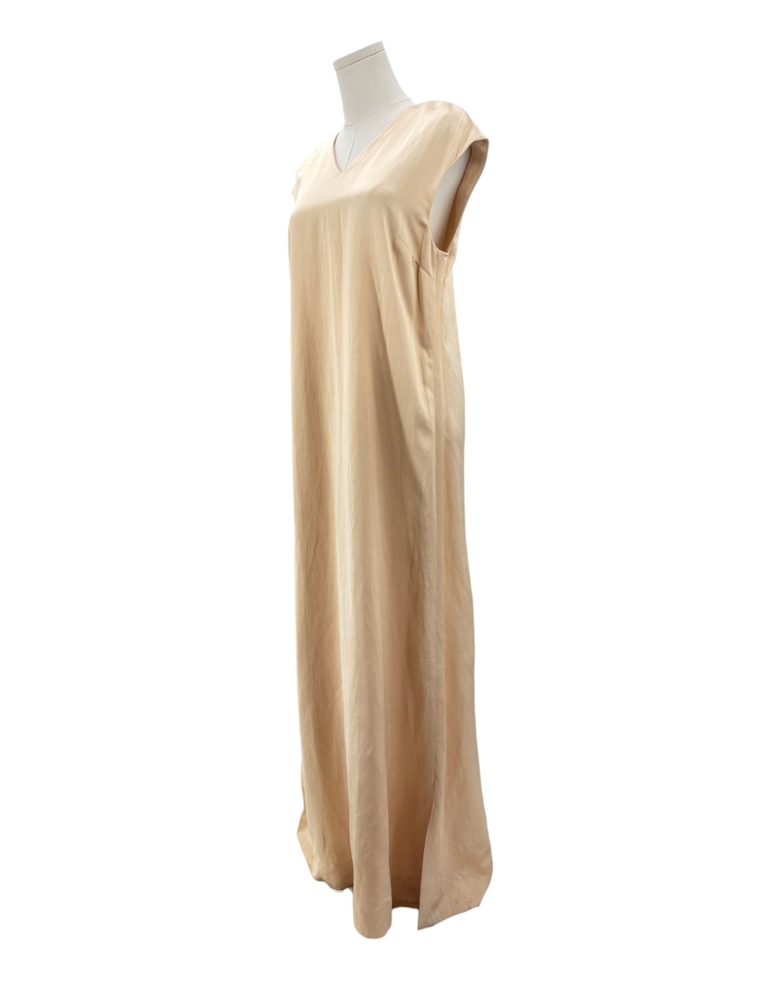 Beige dress on a mannequin against a white background