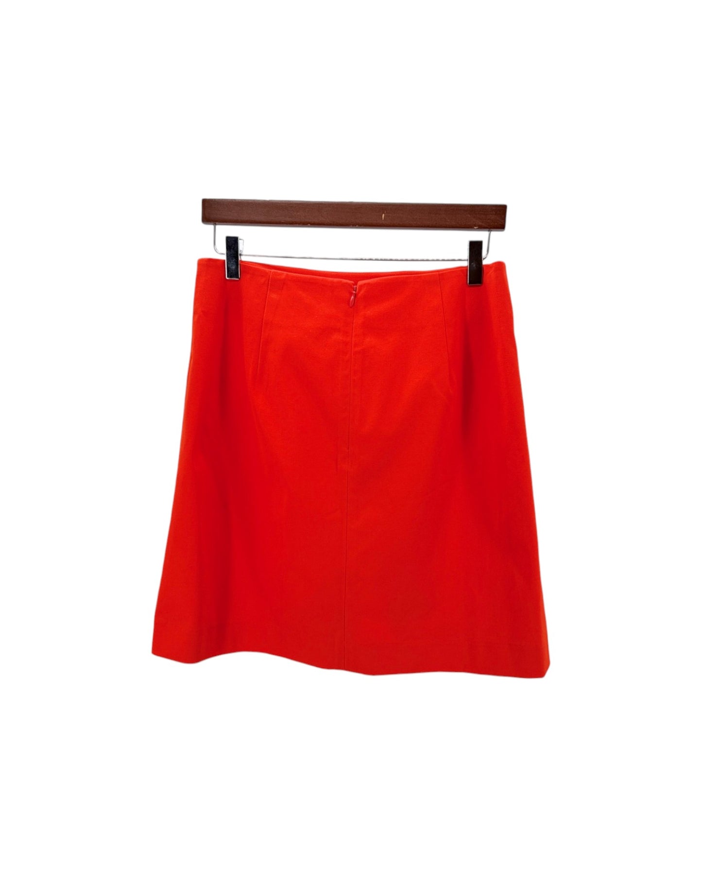 Red skirt on a hanger against a white background