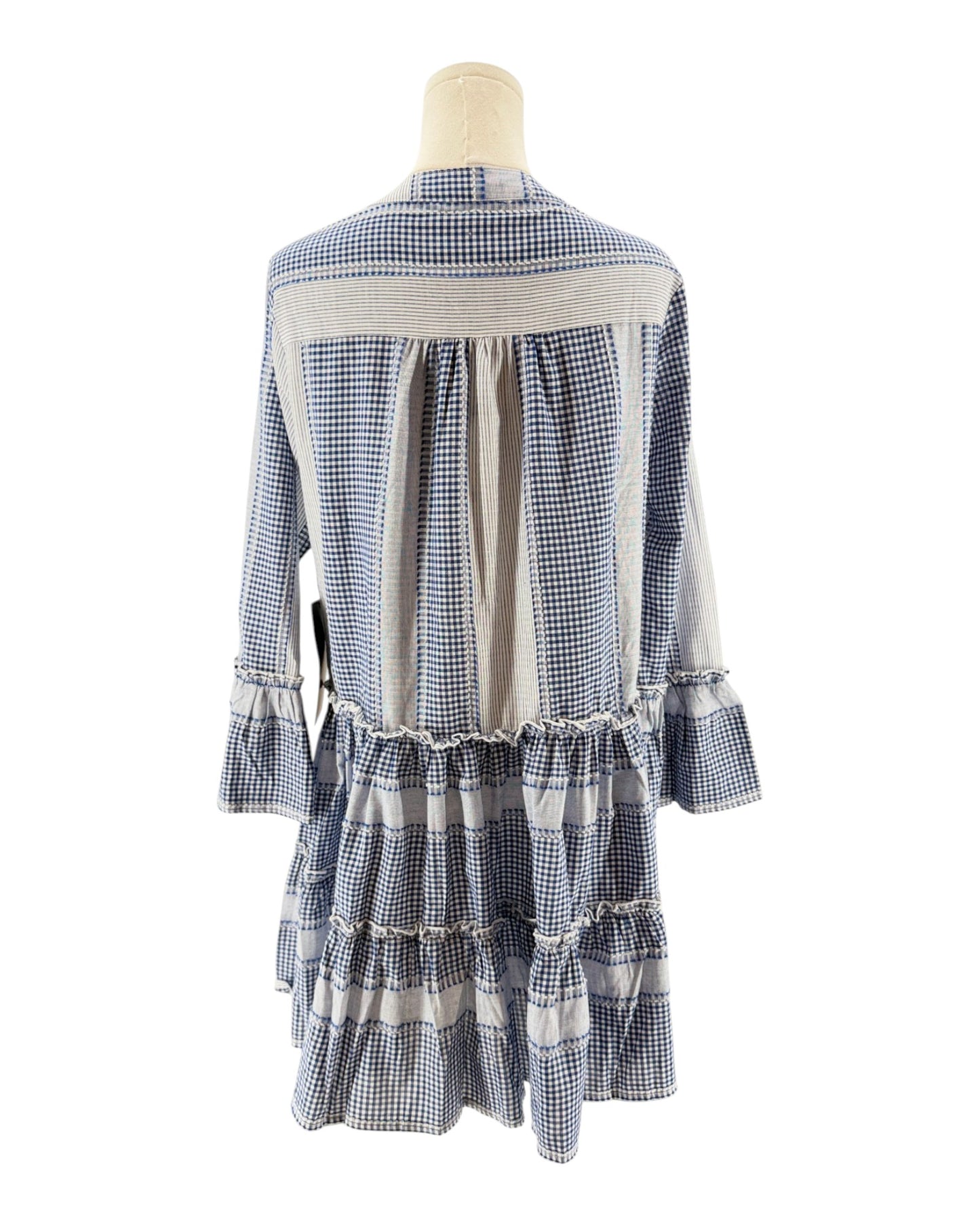 Blue and white checkered dress on a mannequin against a white background