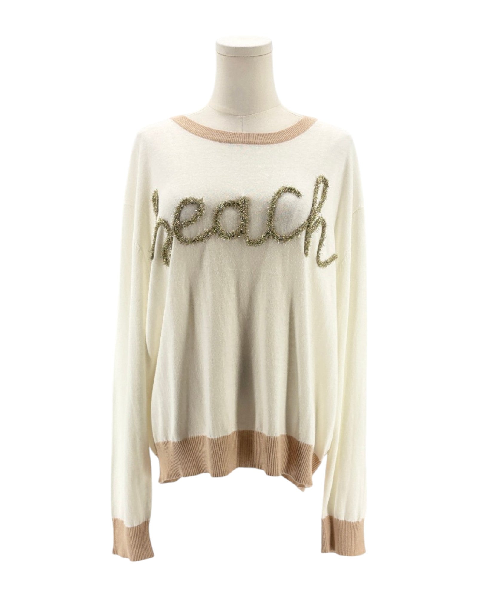 Beige sweater with 'beach' text on a mannequin against a white background