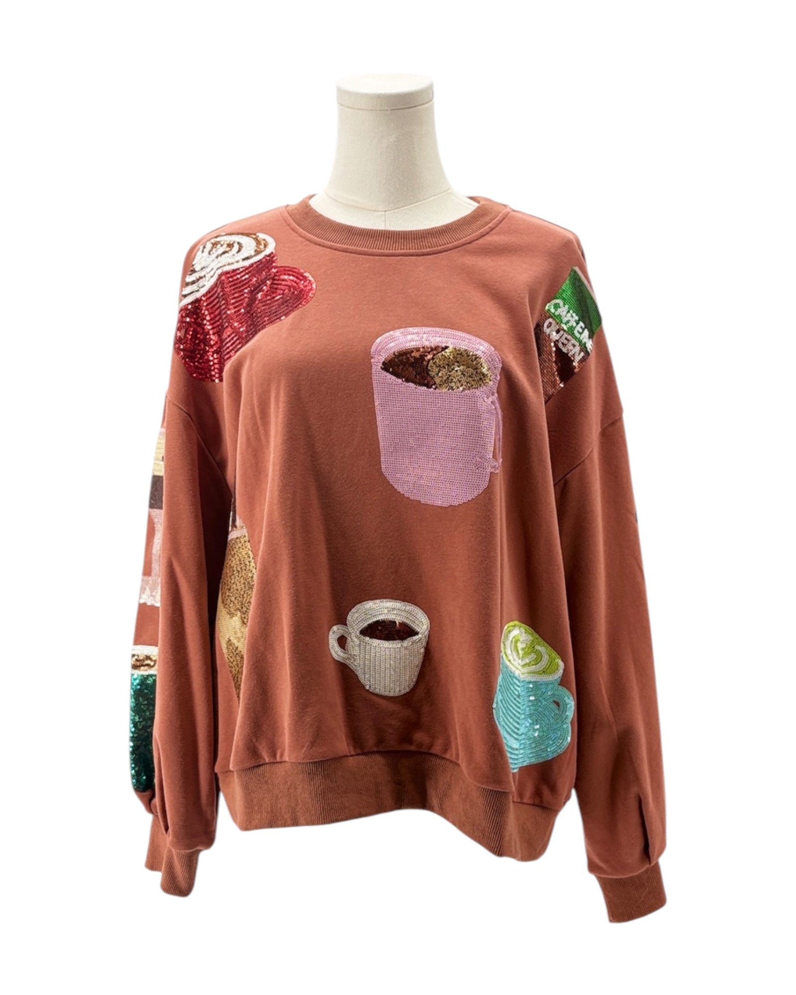 Brown sweatshirt with coffee-themed patches on a mannequin against a white background
