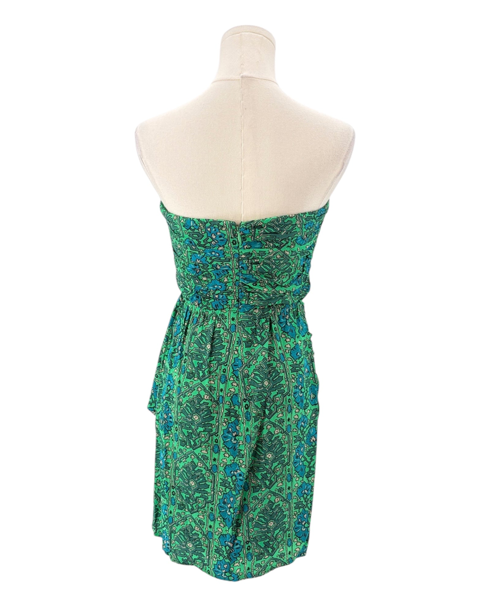 Green floral strapless dress on a mannequin against a white background