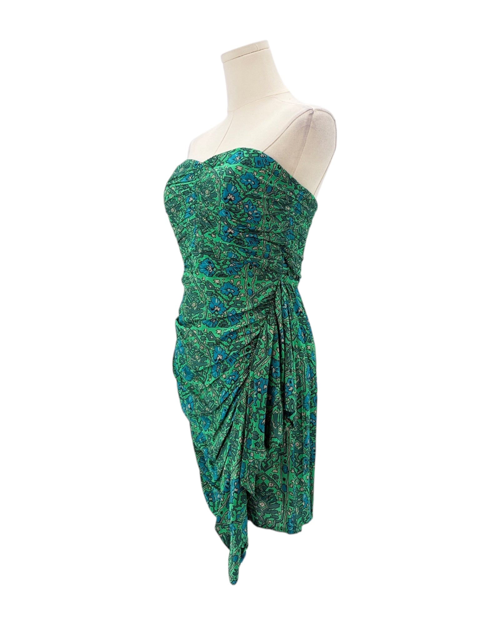 Green strapless dress on a mannequin against a white background