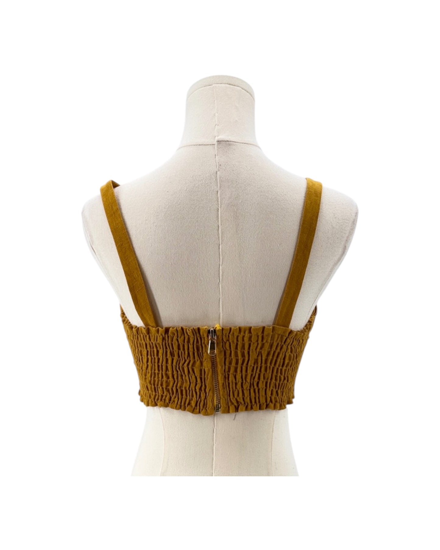 Mustard yellow crop top with straps on a mannequin against a white background