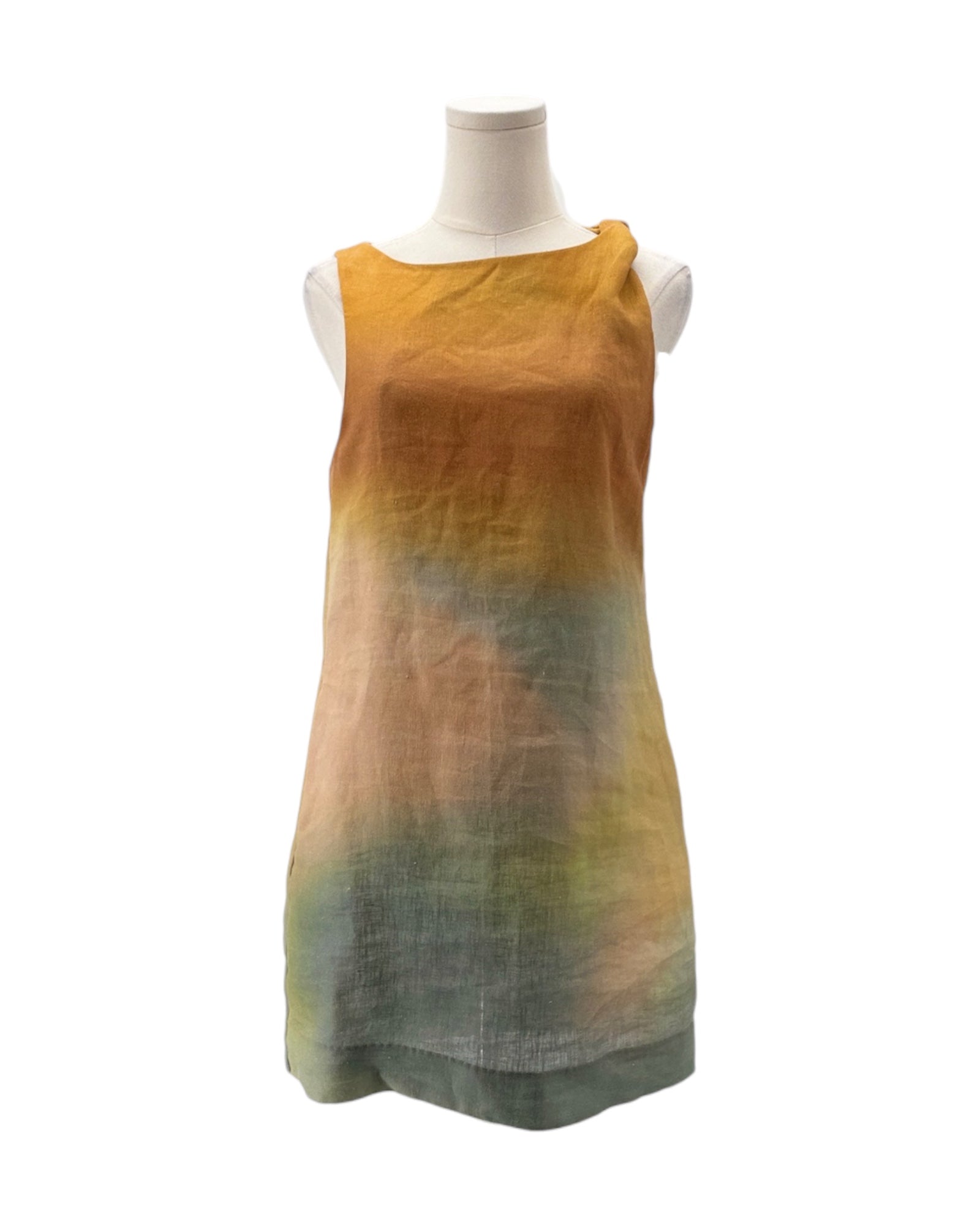 Mannequin wearing a sleeveless dress with a gradient of yellow to green on a white background