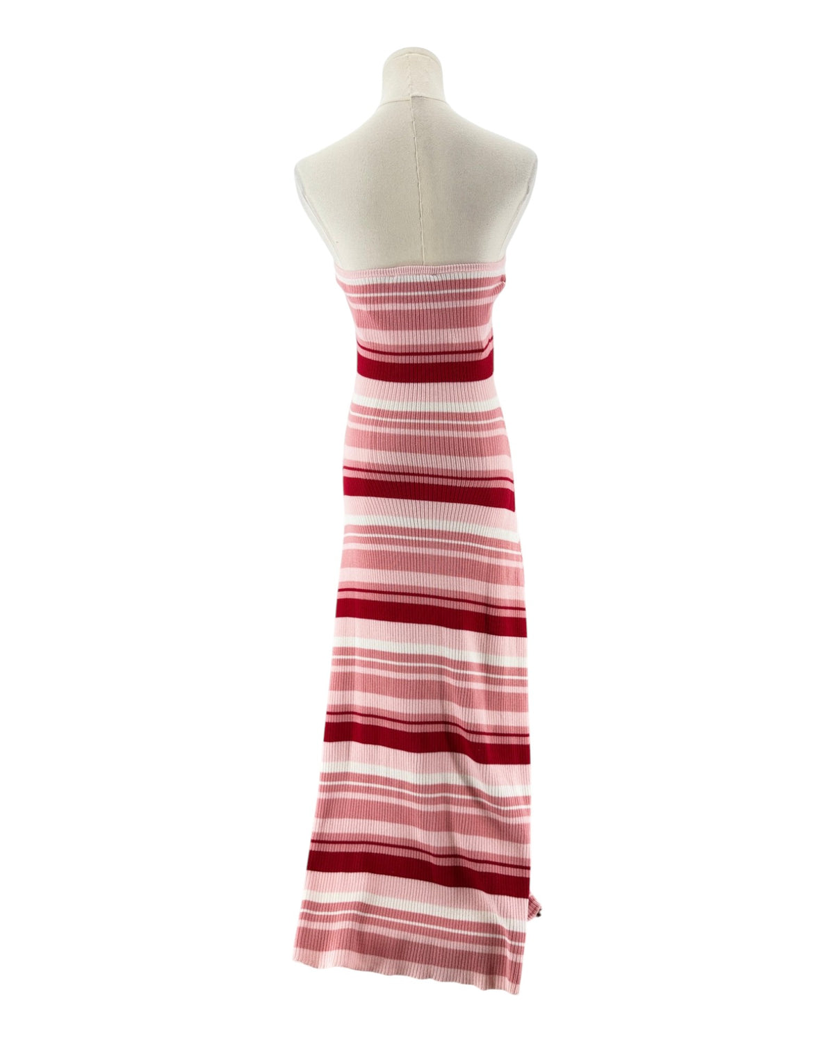 A strapless knit maxi dress with horizontal pink, red, and white stripes, displayed on a cream-colored mannequin torso against a plain white background.