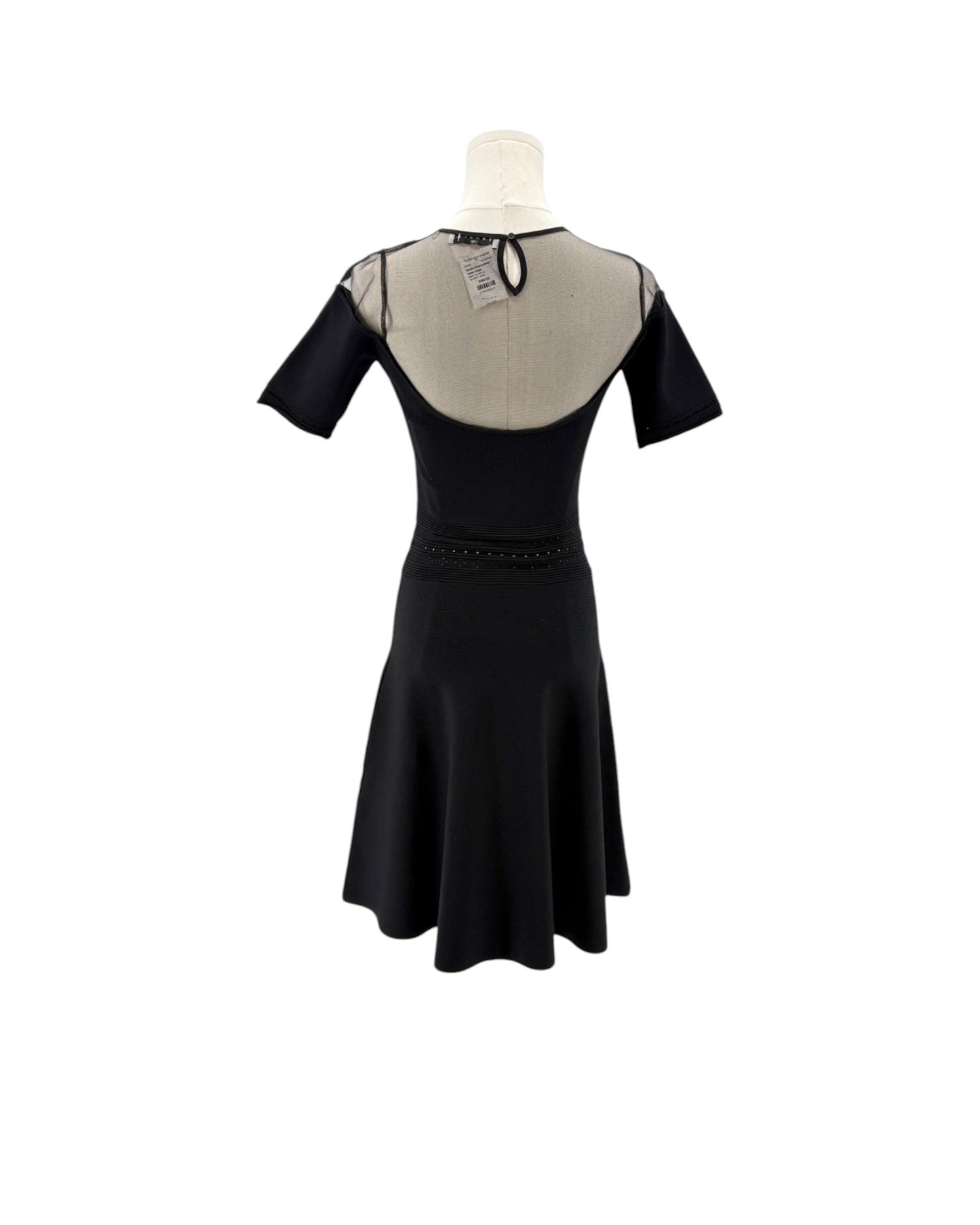 Black dress with sheer back on a mannequin against a white background
