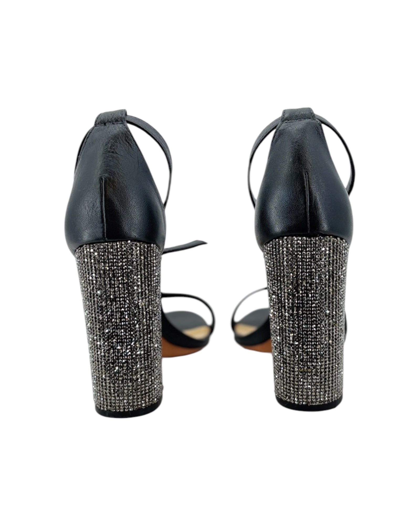 Black high-heeled shoes with rhinestone embellishments on a white background
