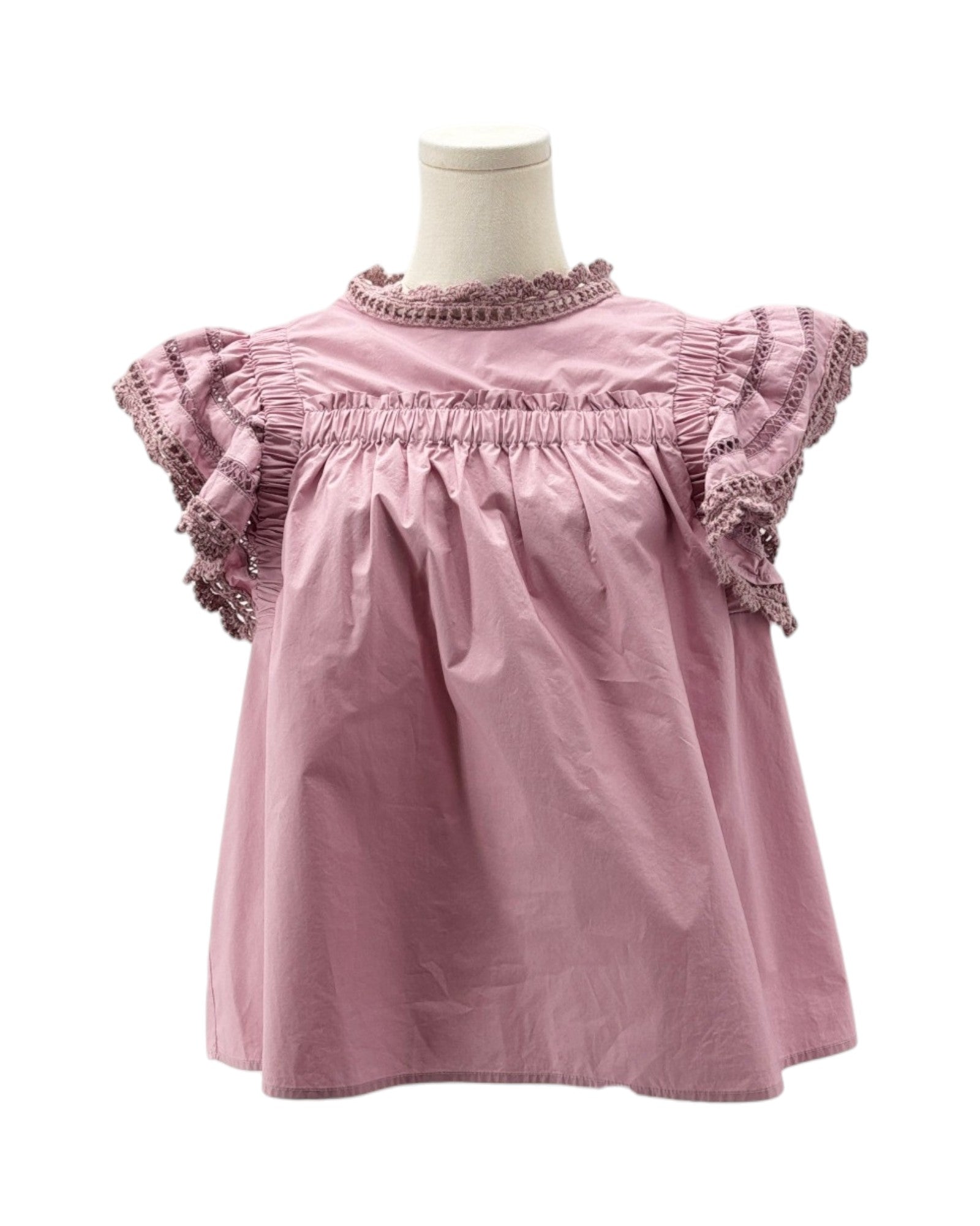 Pink blouse with ruffled sleeves on a mannequin against a white background