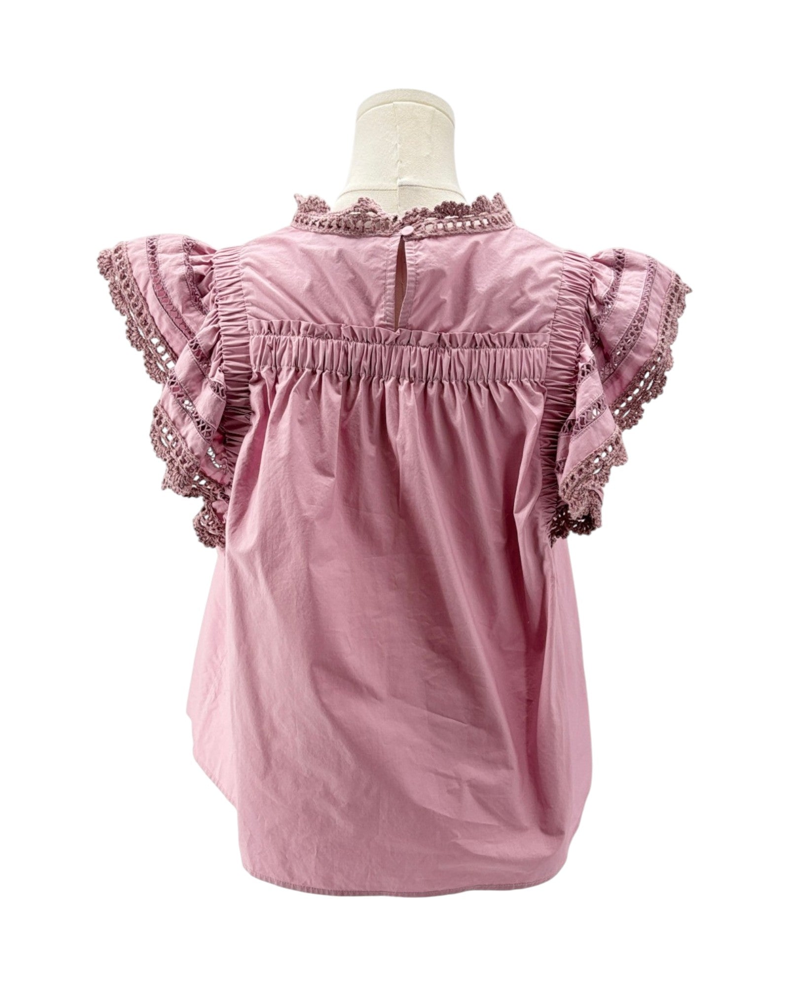 Pink blouse with ruffled sleeves on a mannequin against a white background