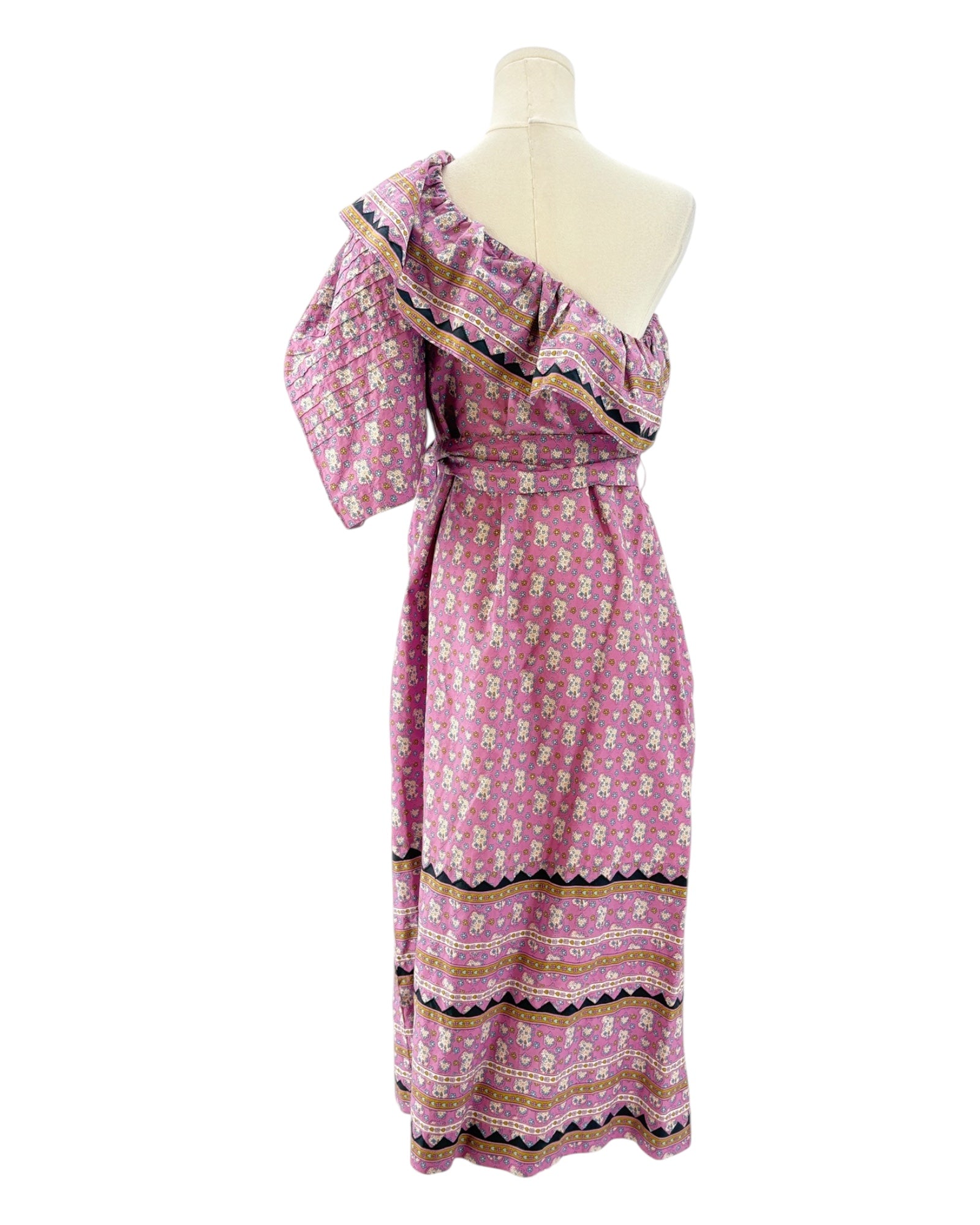 Pink floral dress on a mannequin against a white background