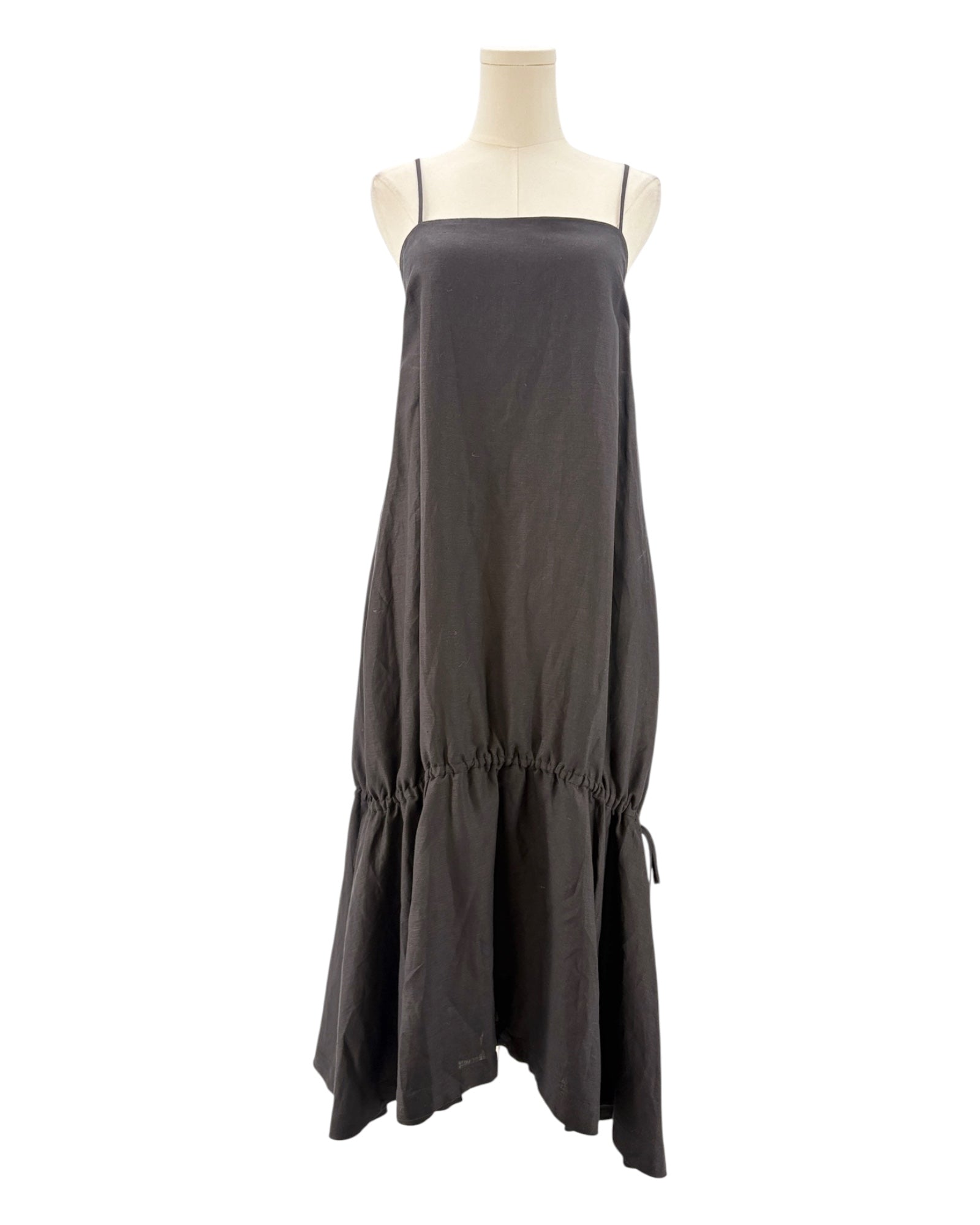 Black dress on a mannequin against a white background