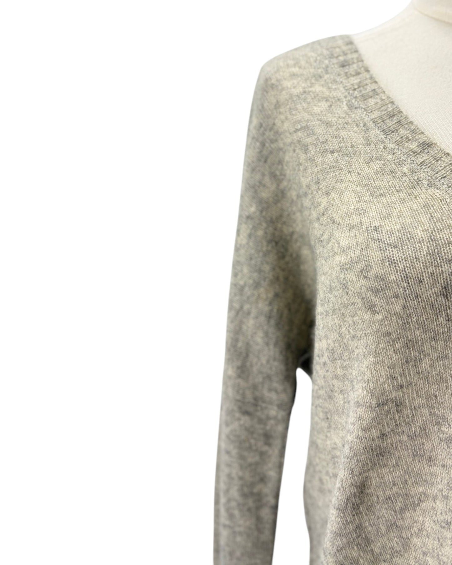Gray sweater on a mannequin with a white background