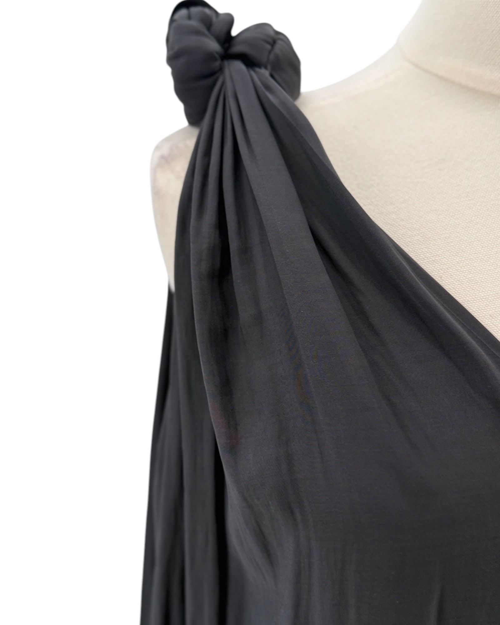 Black top with knot details on a mannequin against a white background