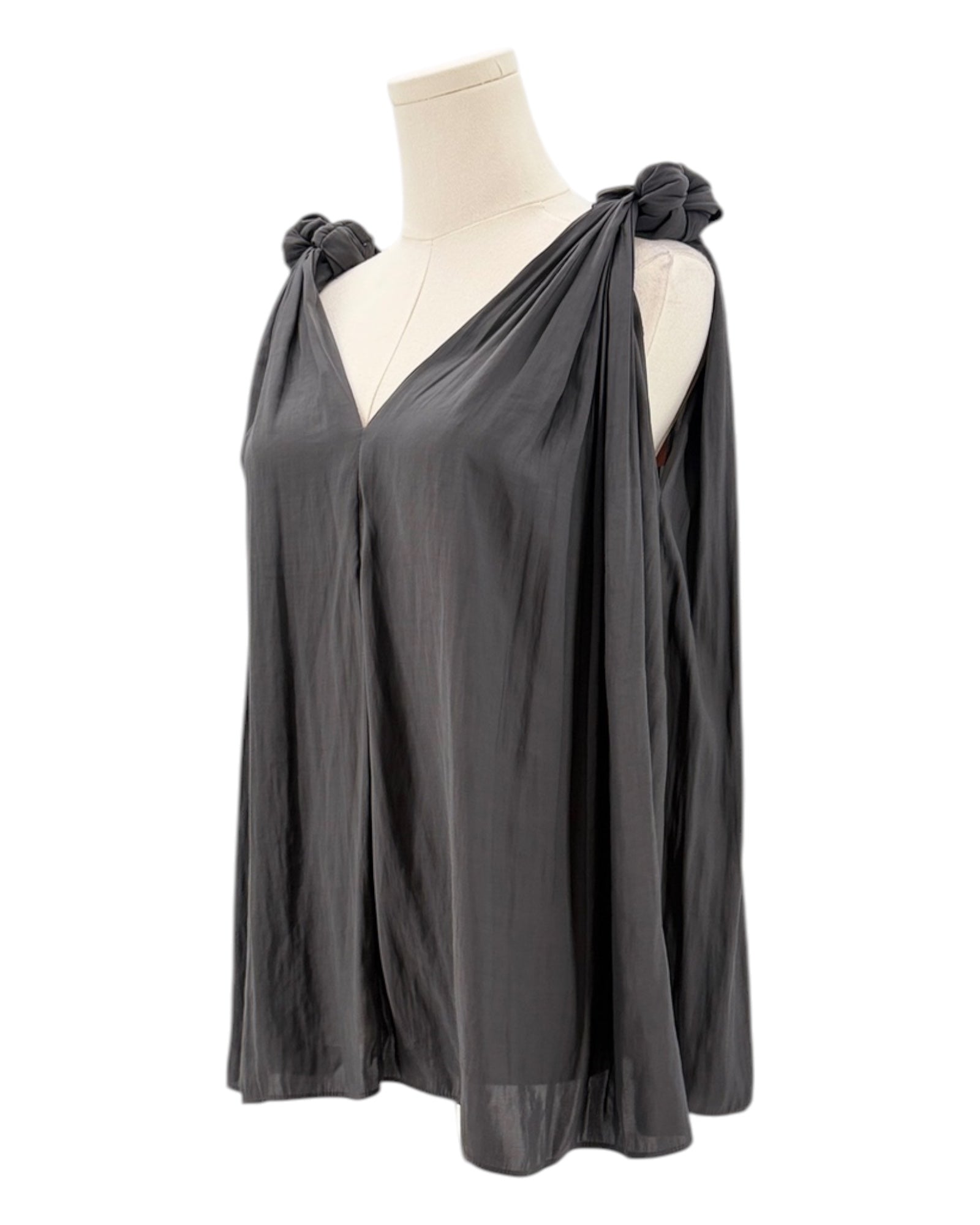 Black top with knot details on a mannequin against a white background