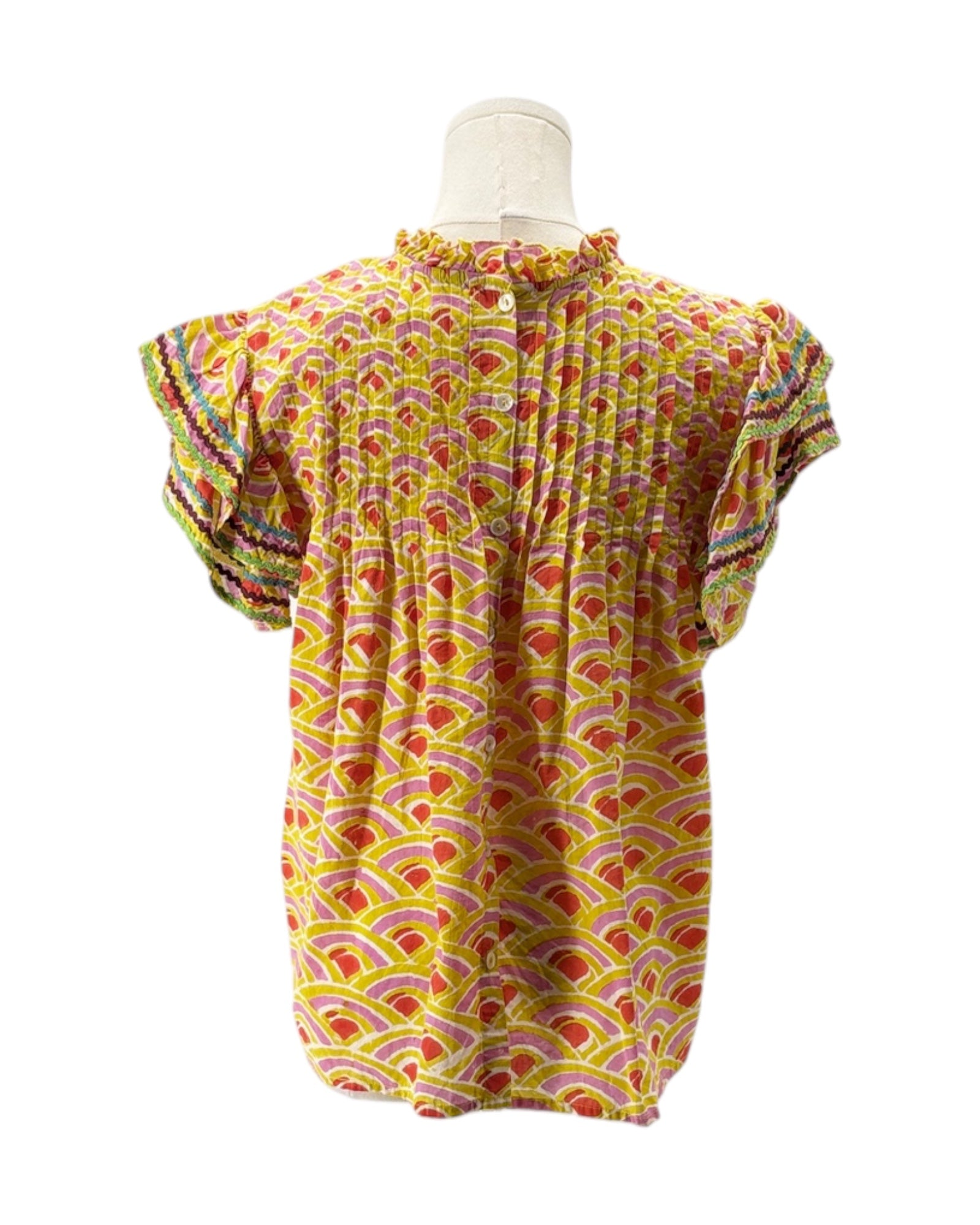 Colorful patterned top on a mannequin against a white background