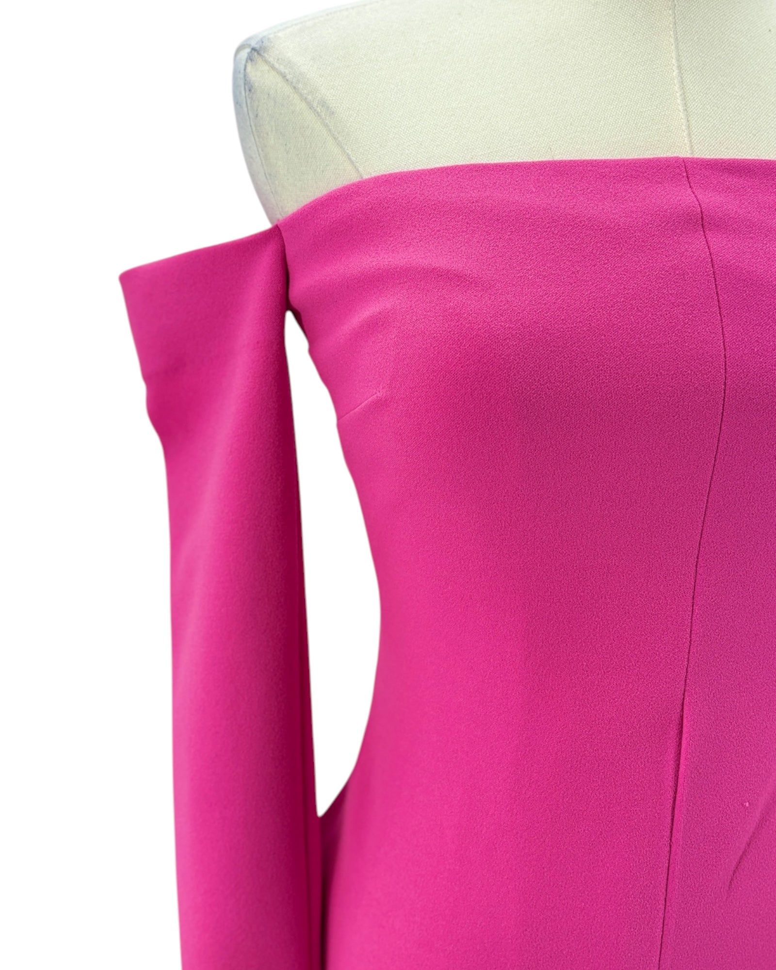 Close-up of a bright pink fabric on a mannequin with a white background