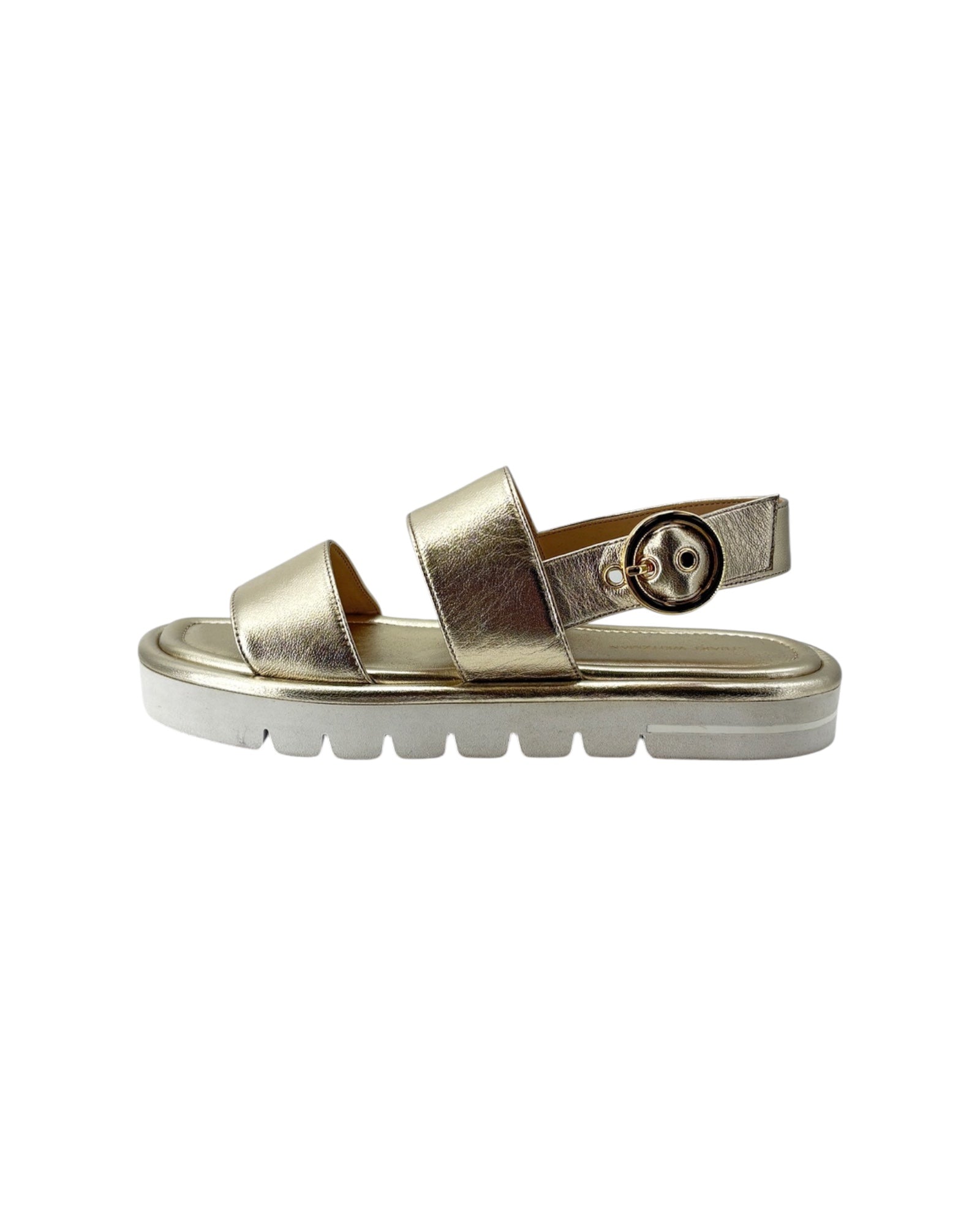 Gold sandal with a white sole on a white background
