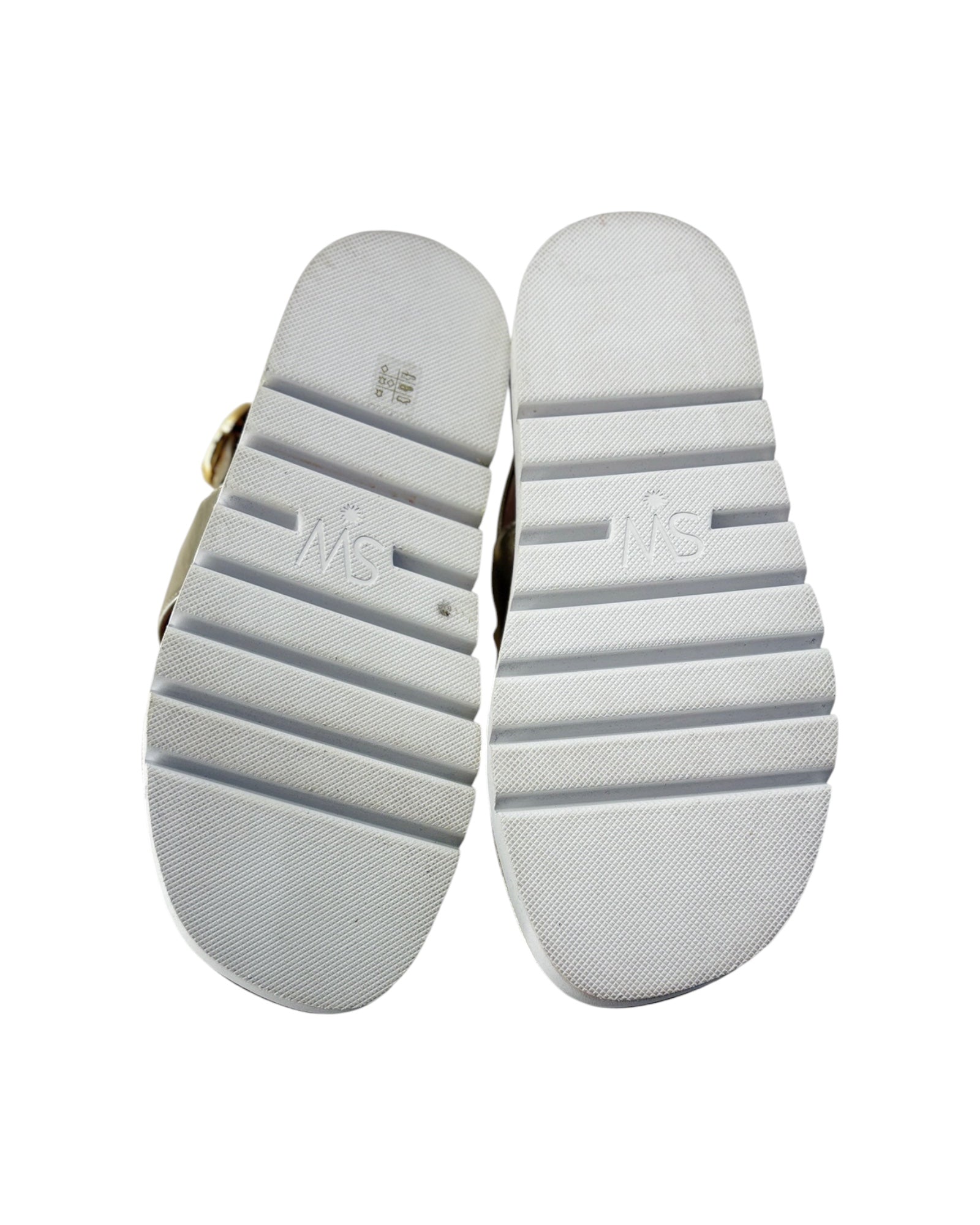 White shoe soles with visible branding on a white background