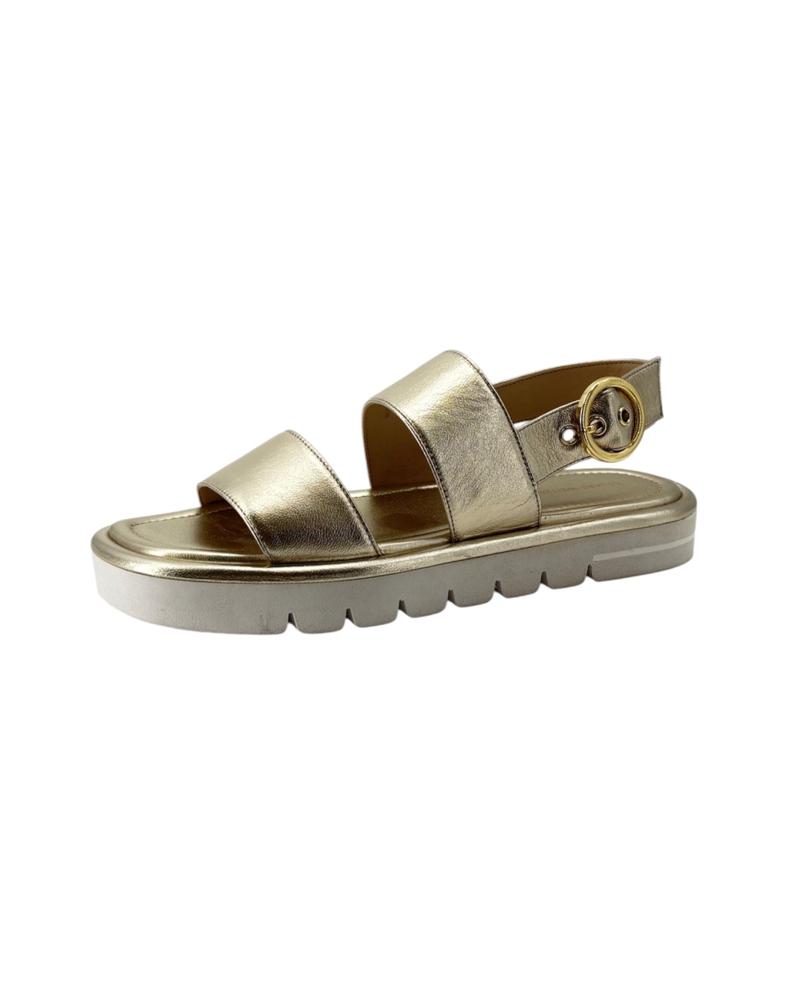 Gold sandal with a platform sole on a white background