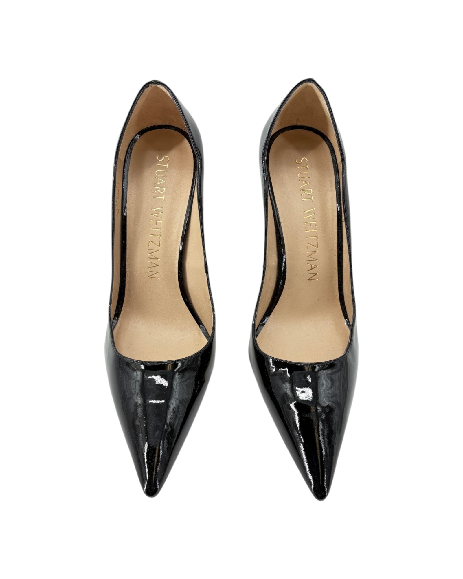 Black patent leather high heels on a white background