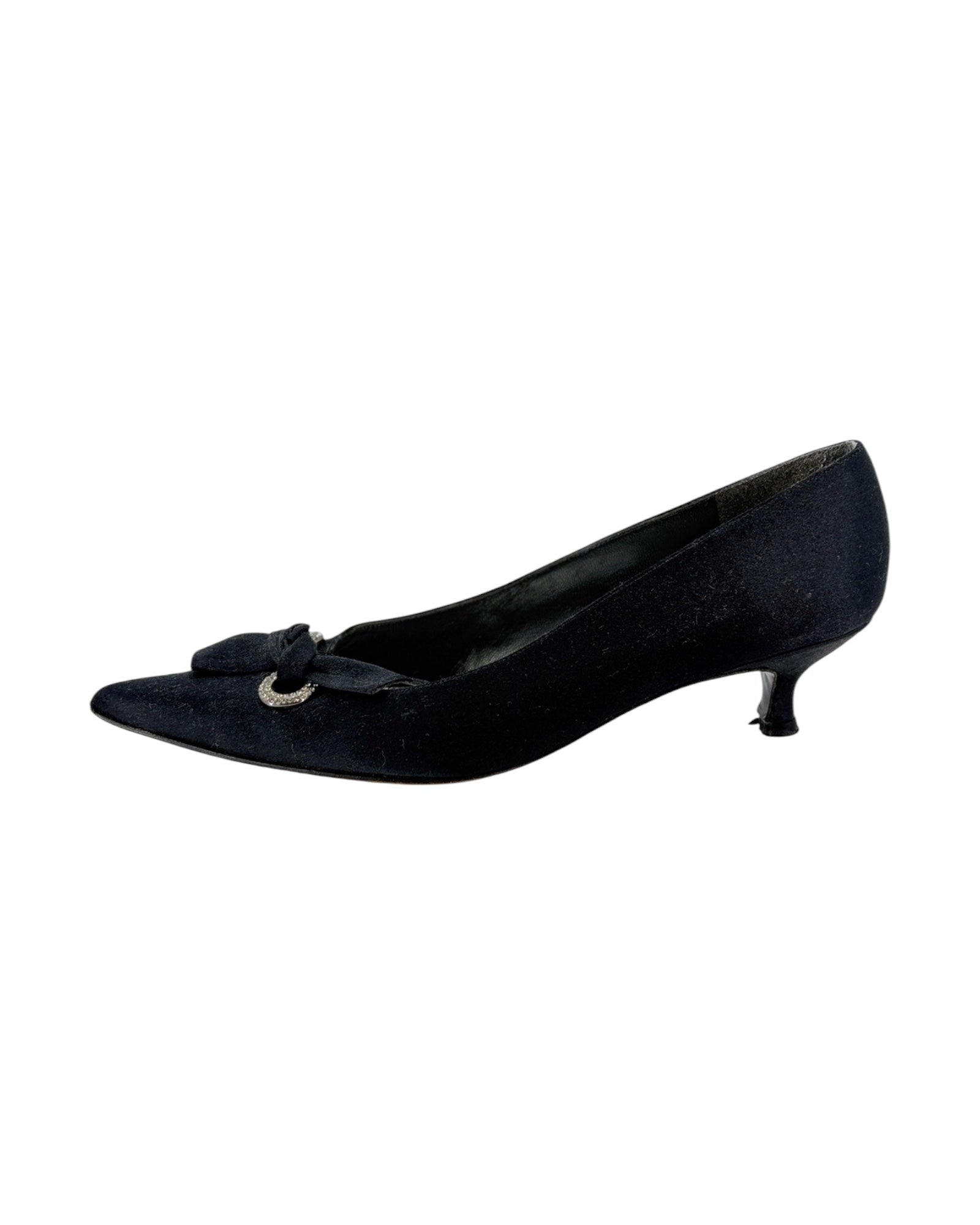 Pair of black high-heeled shoes with bow details on a white background