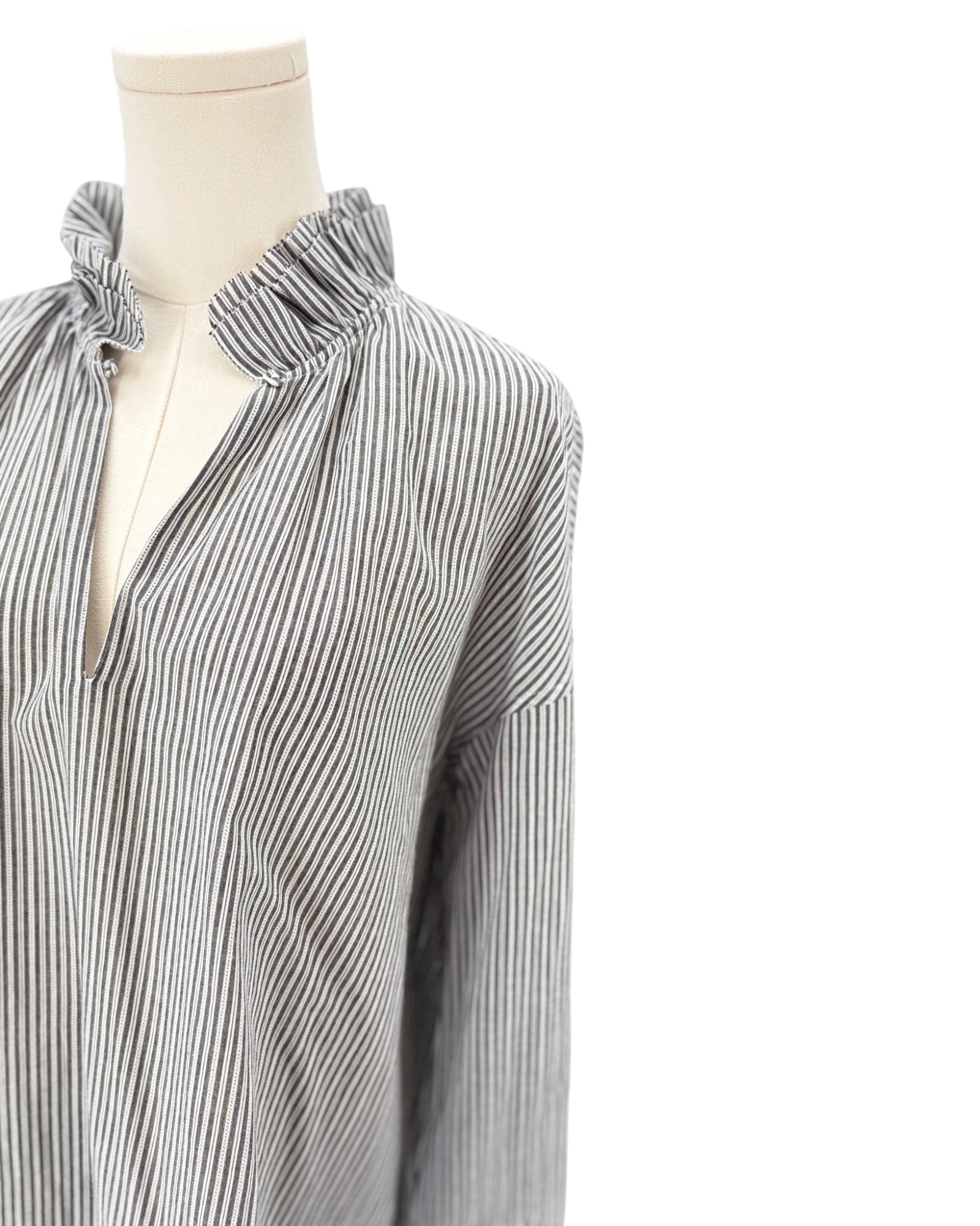Sundays black and white striped shirt on a mannequin against a white background
