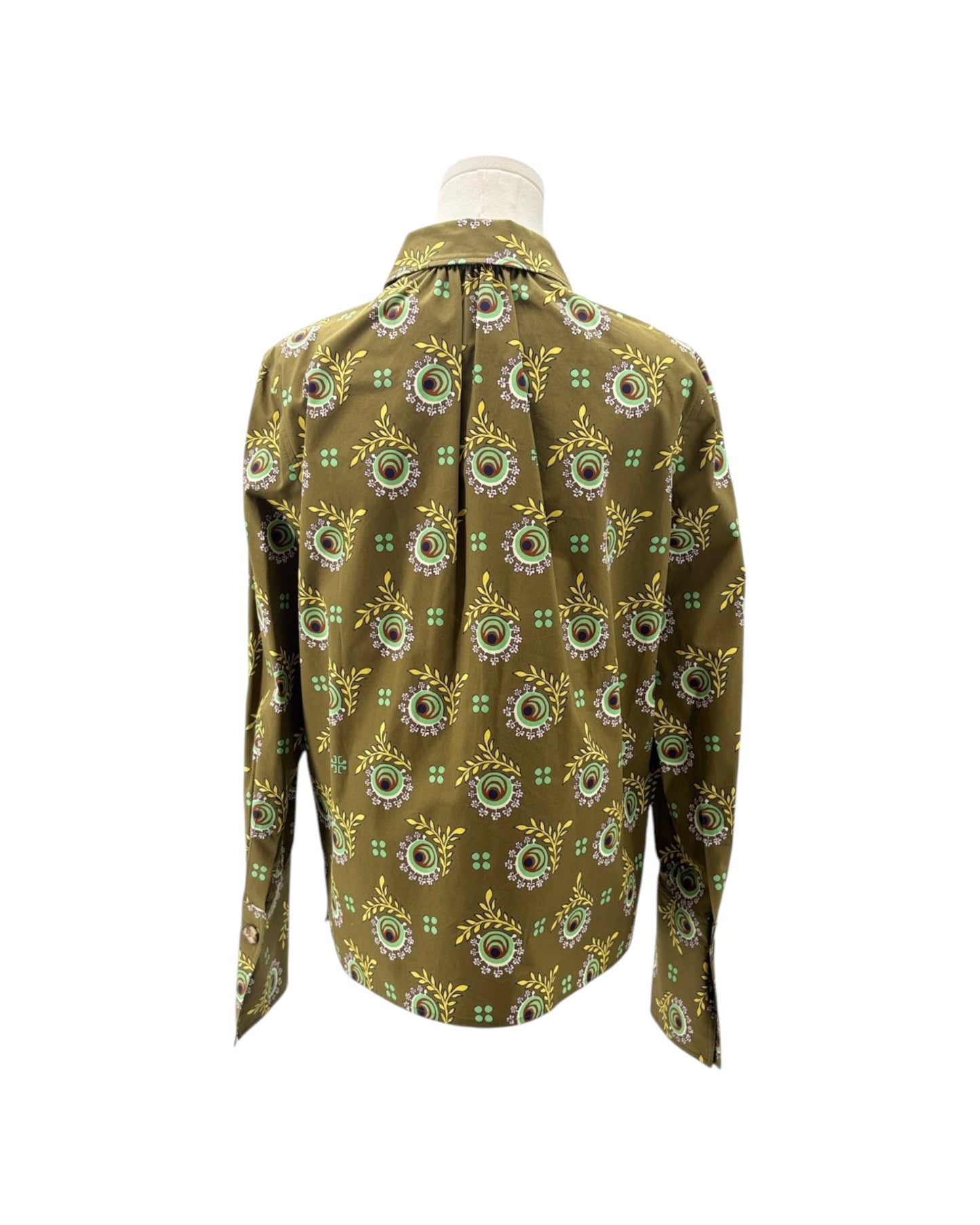 A long-sleeve button-up shirt displayed on a mannequin torso, featuring an olive green base with a repeating circular floral pattern in yellow, white, and light green.