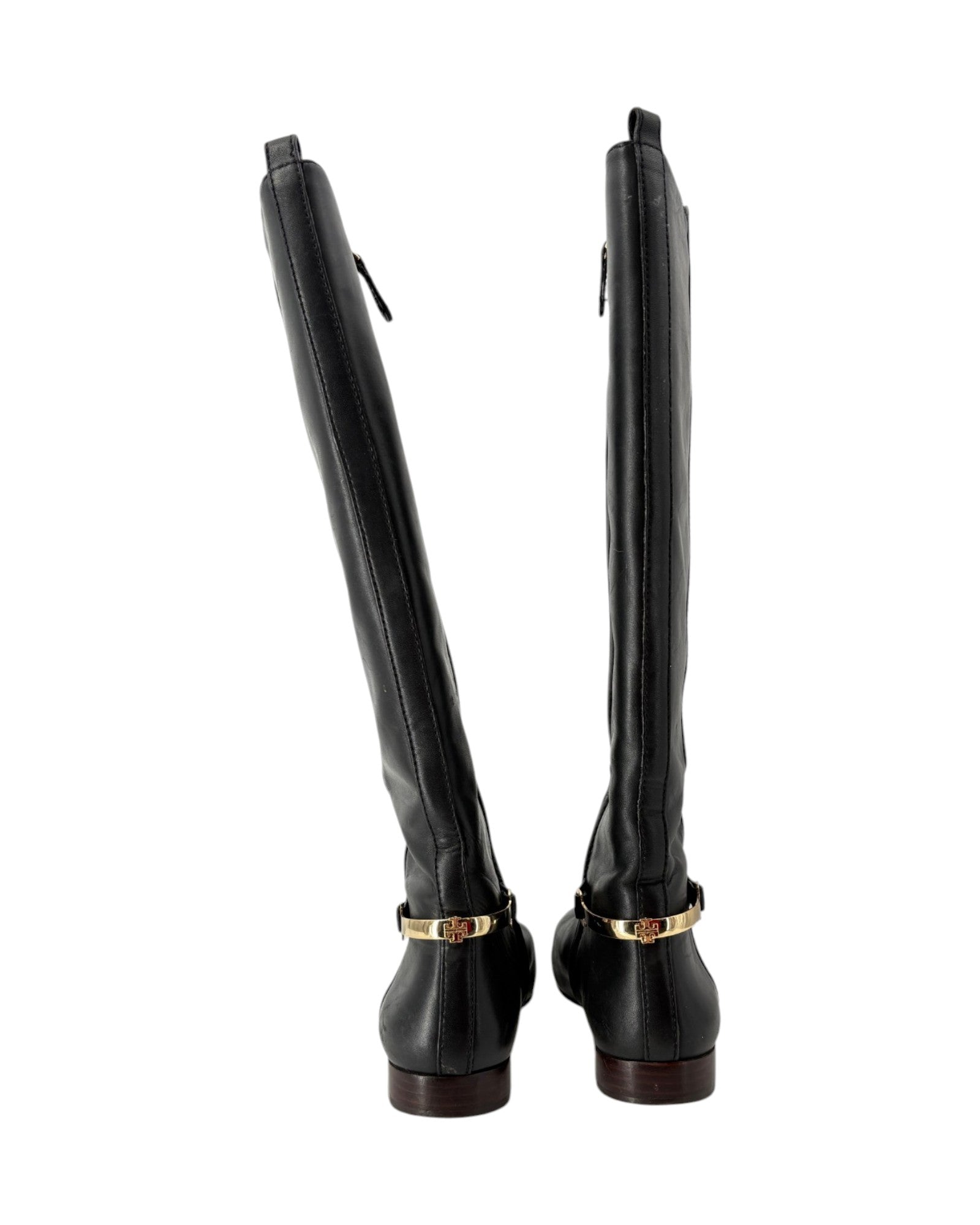 Pair of black knee-high boots with gold accents on a white background