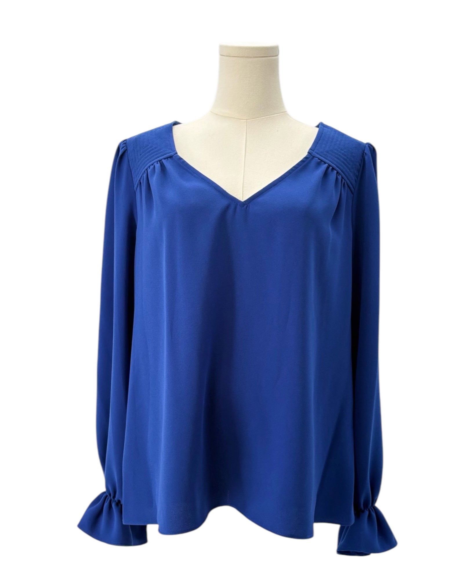 Blue blouse on a mannequin against a white background
