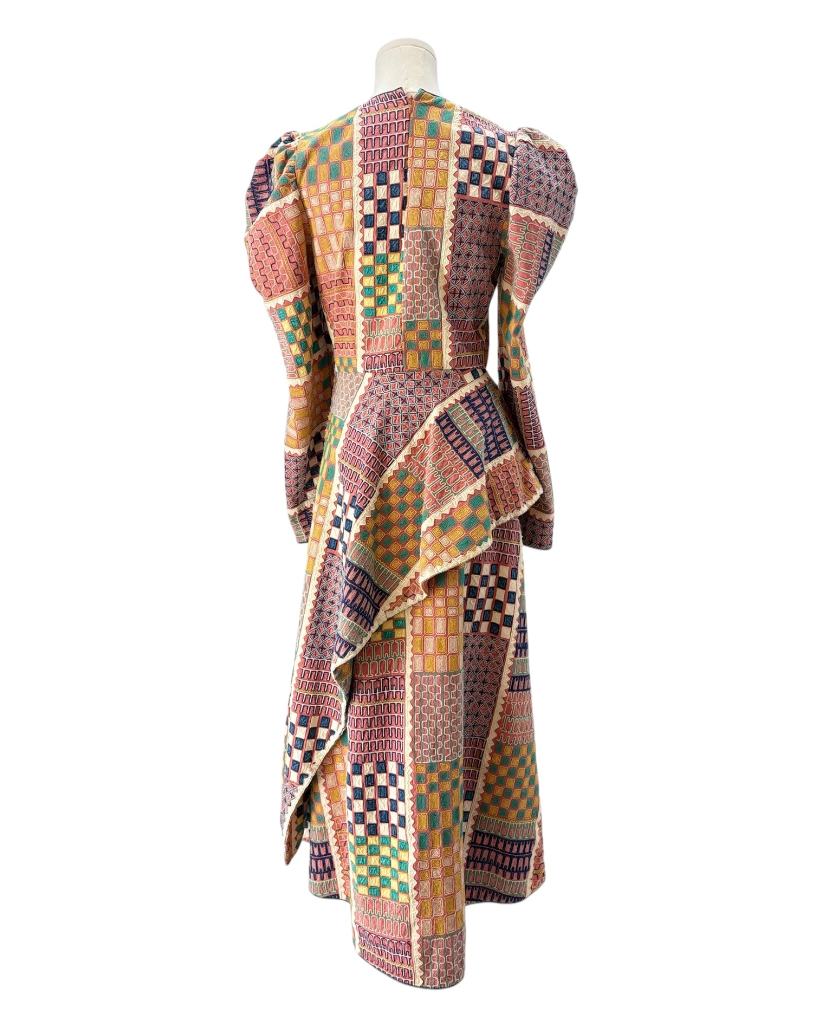 Multicolored patchwork dress on a mannequin against a white background