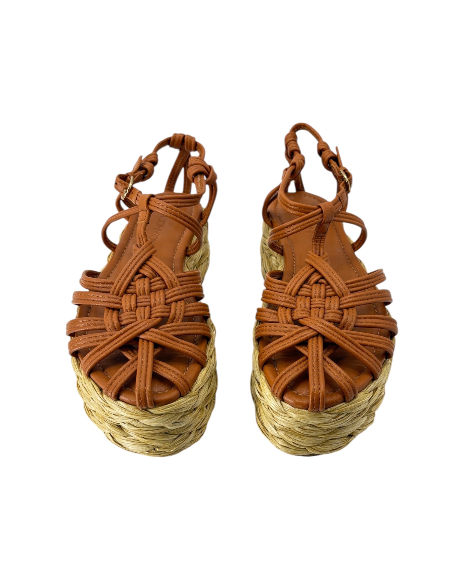 Pair of brown woven sandals with straw sole on a white background