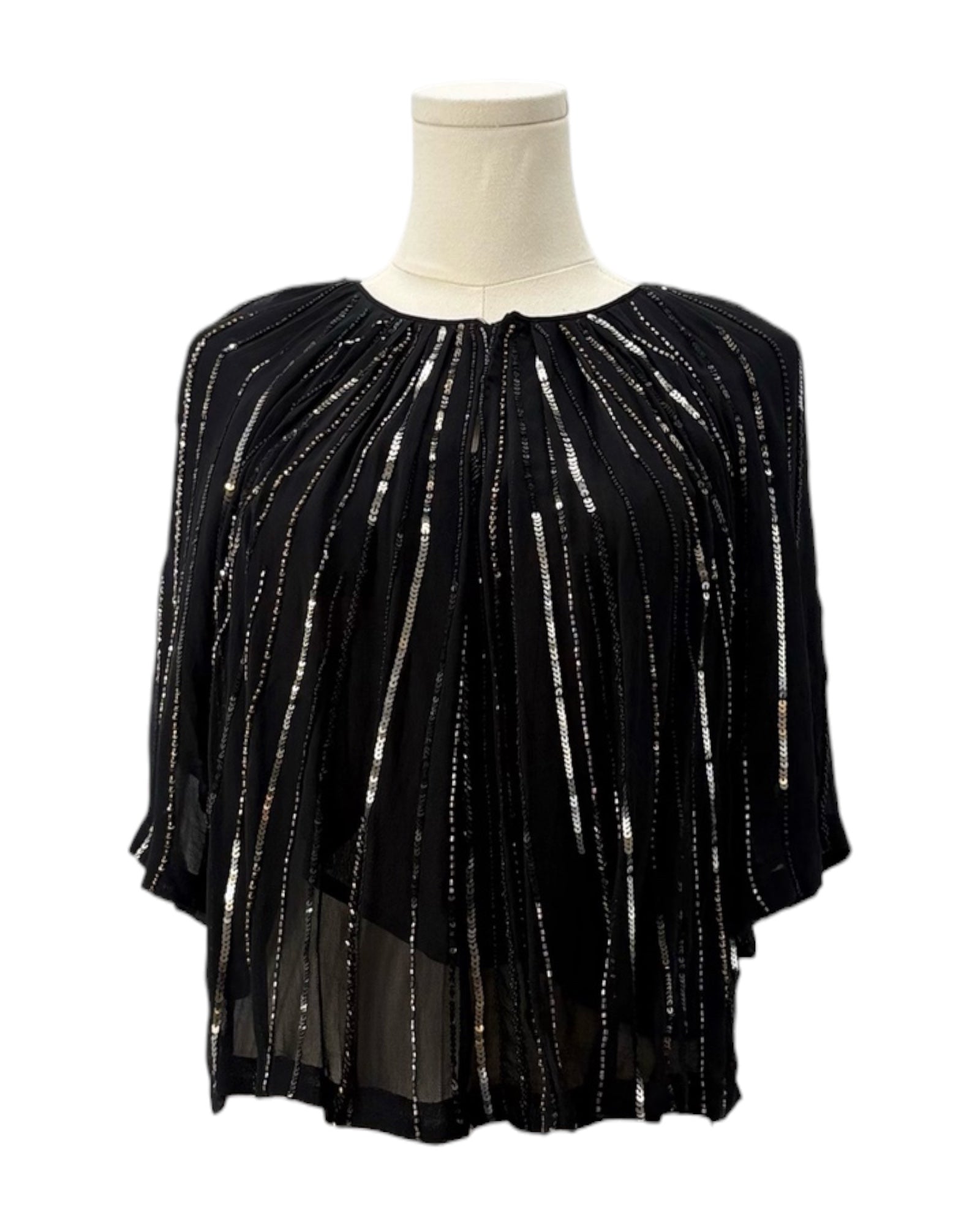 Black sequin top on a mannequin against a white background