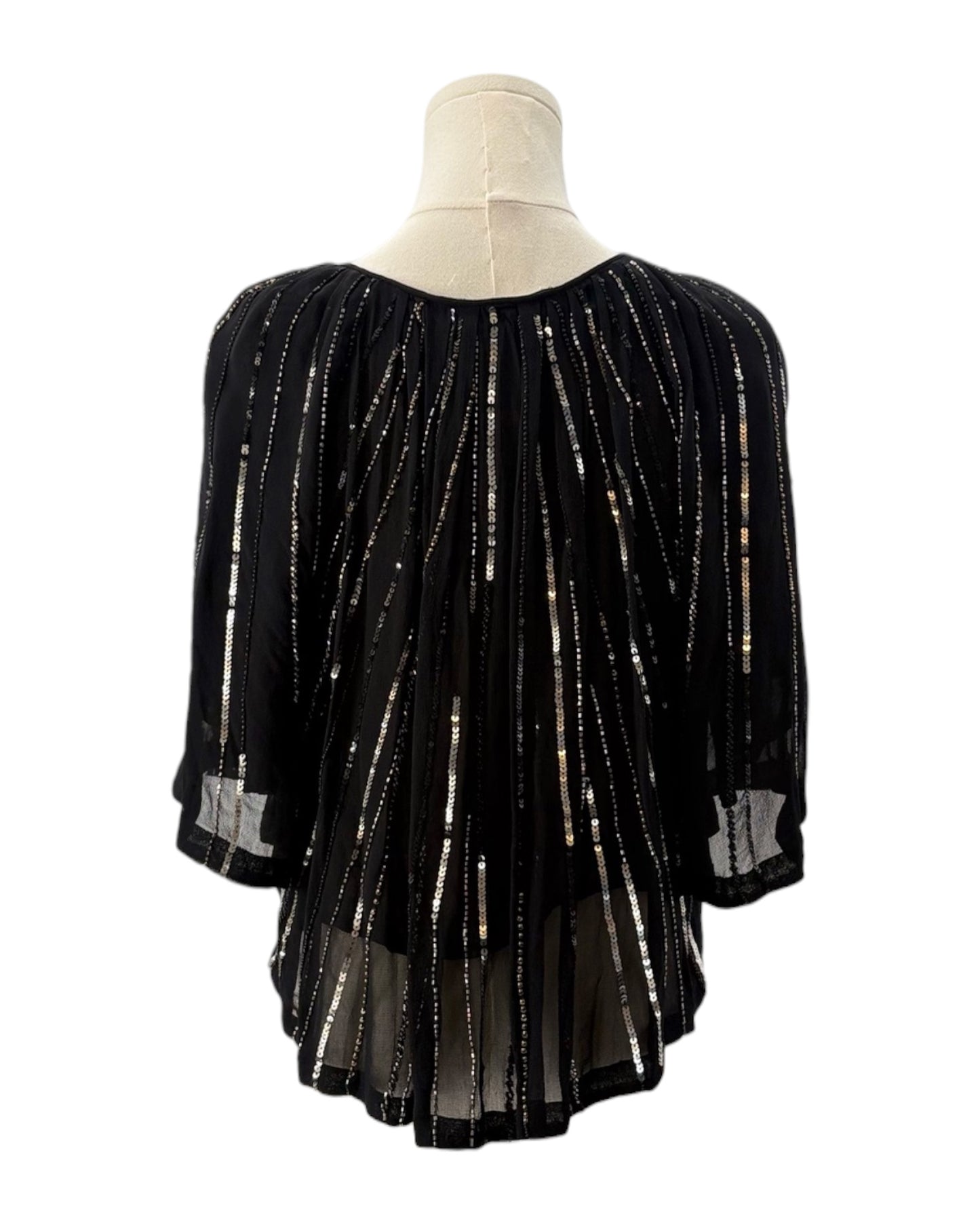 Black beaded blouse on a mannequin with a white background