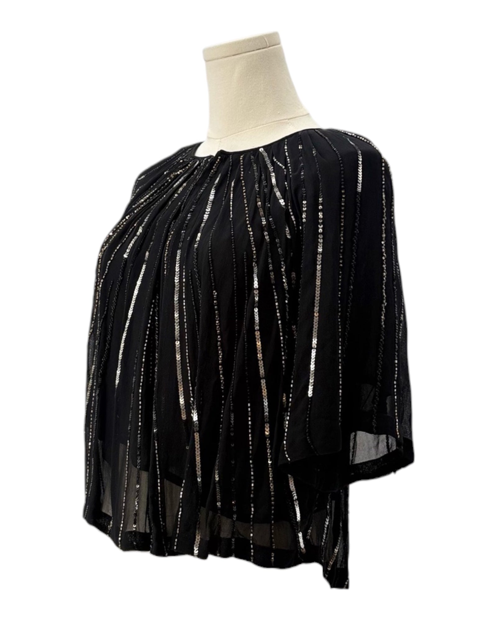 Black top with silver embellishments on a mannequin against a white background