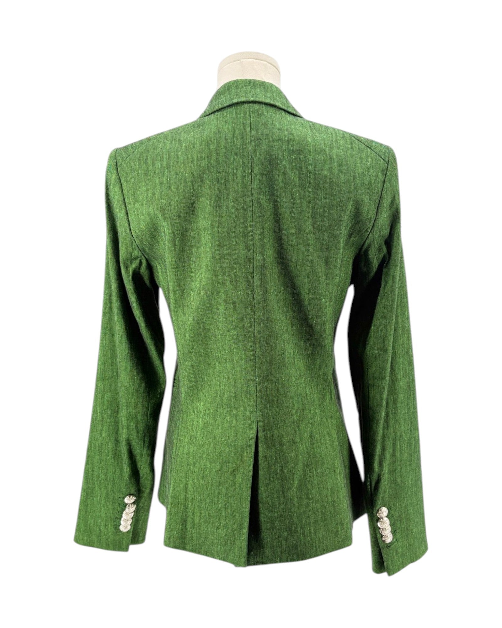 Green blazer on a mannequin against a white background