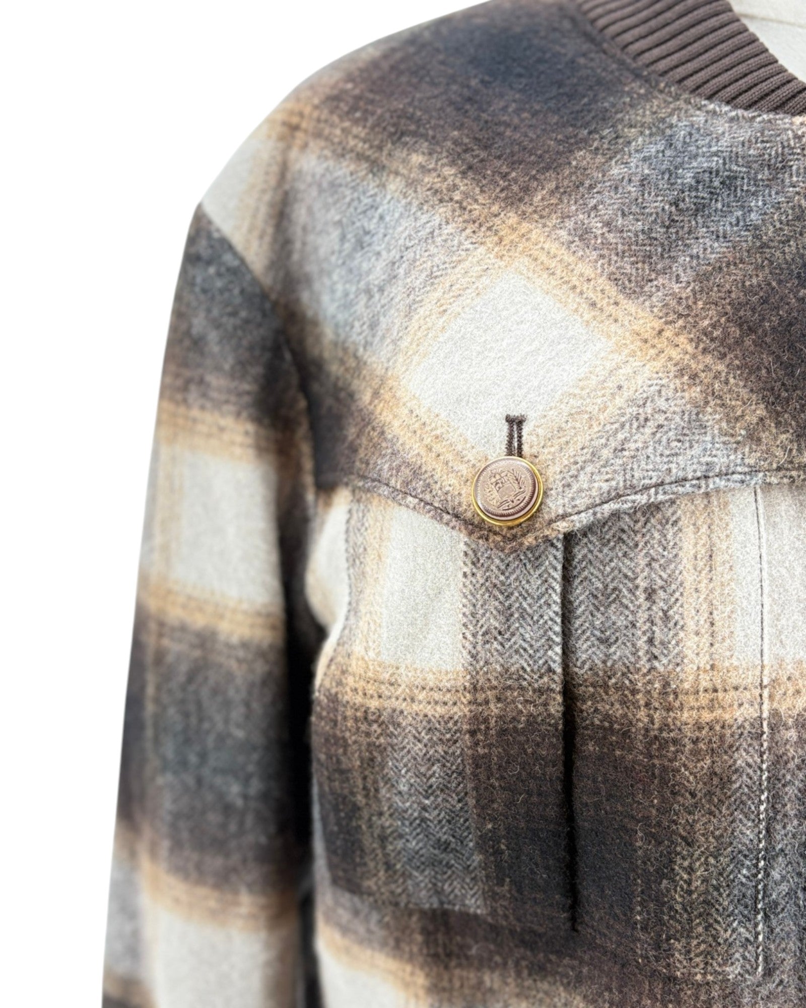 Plaid patterned fabric with a button on a white background