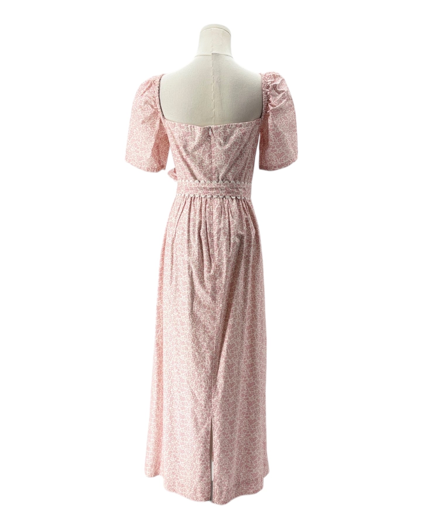 Pink dress on a mannequin against a white background