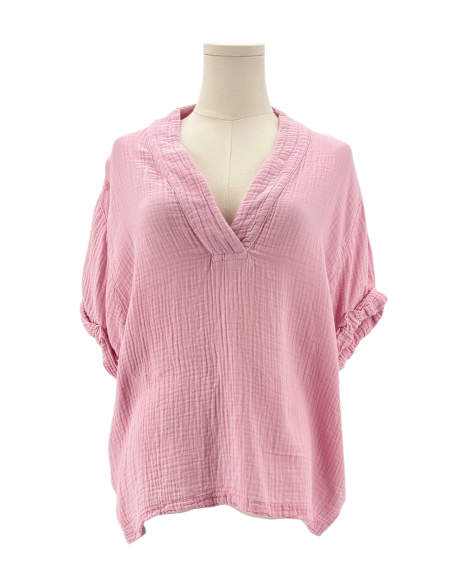 Pink top on a mannequin against a white background