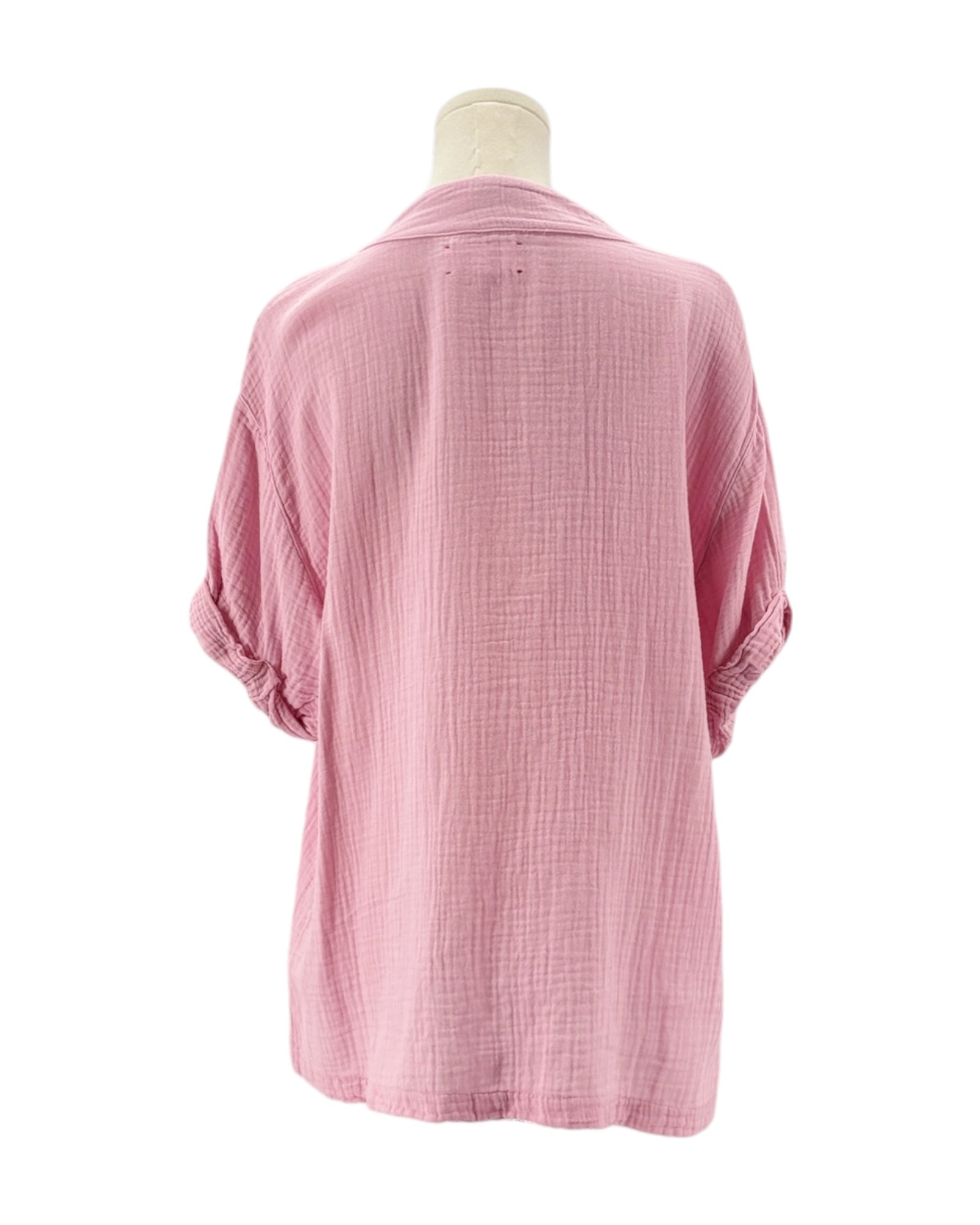 Pink textured shirt on a mannequin against a white background