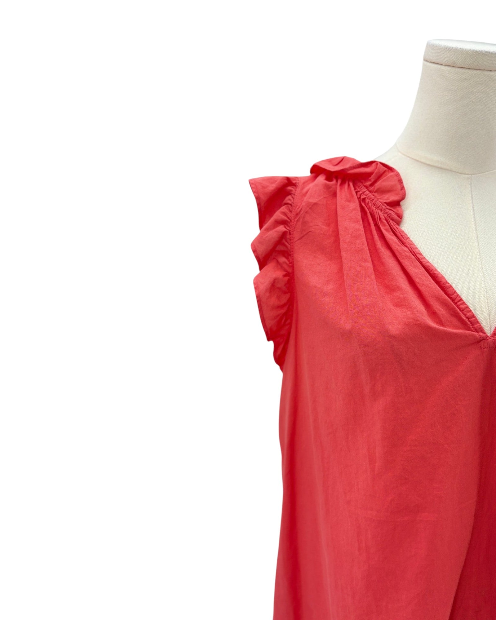 Red sleeveless top on a mannequin against a white background
