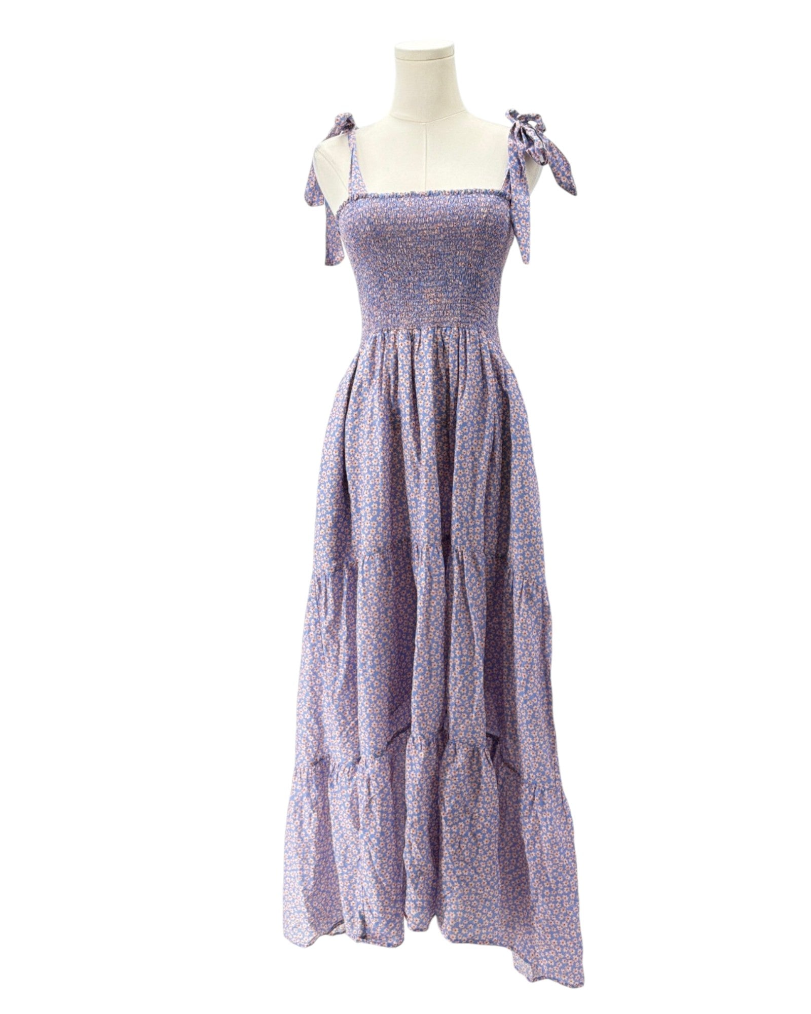 Purple floral dress on a mannequin against a white background