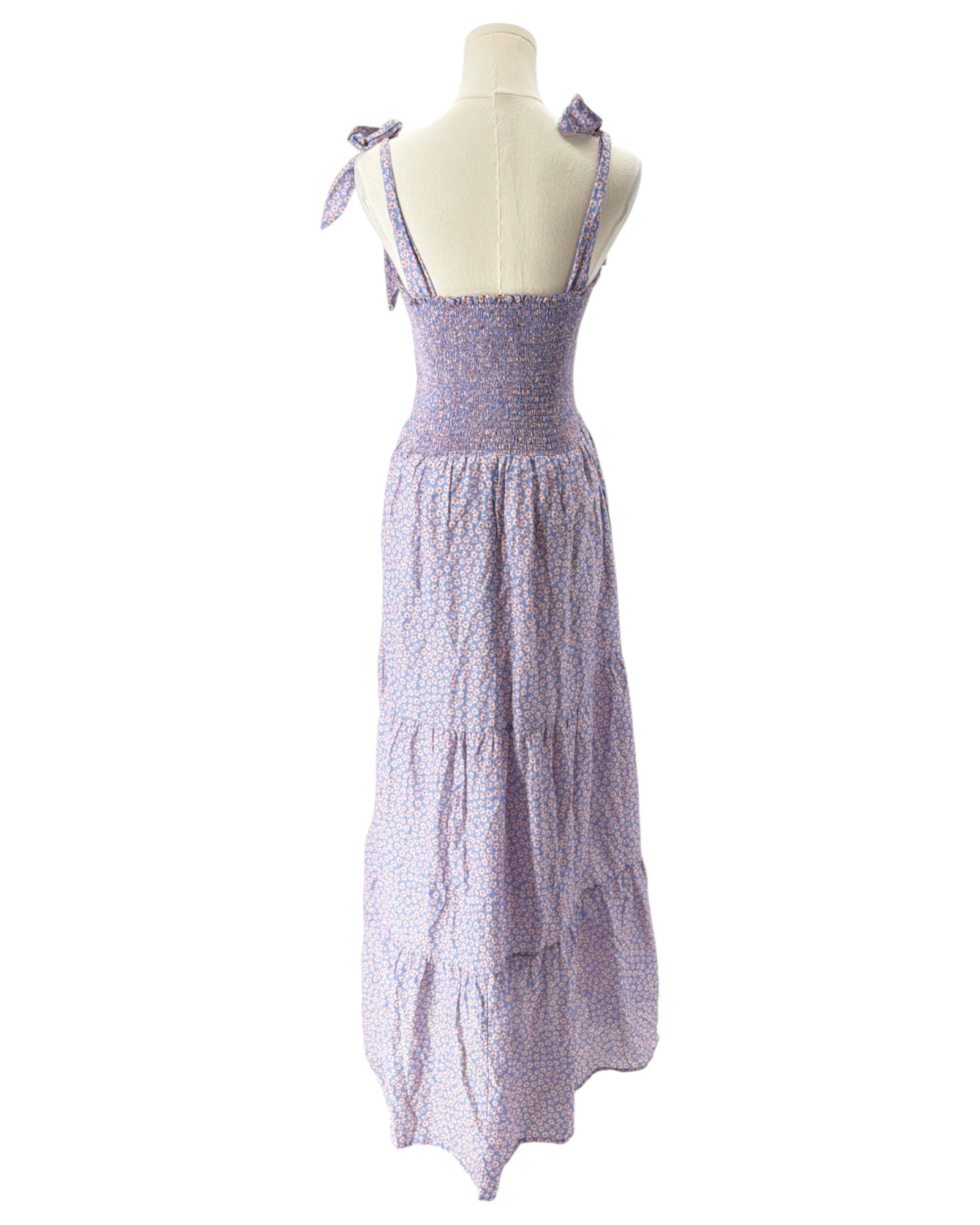 Purple tiered dress on a mannequin against a white background