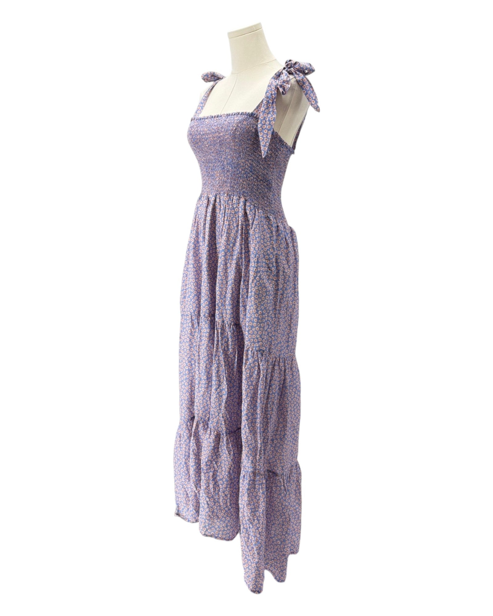 Purple dress on a mannequin against a white background