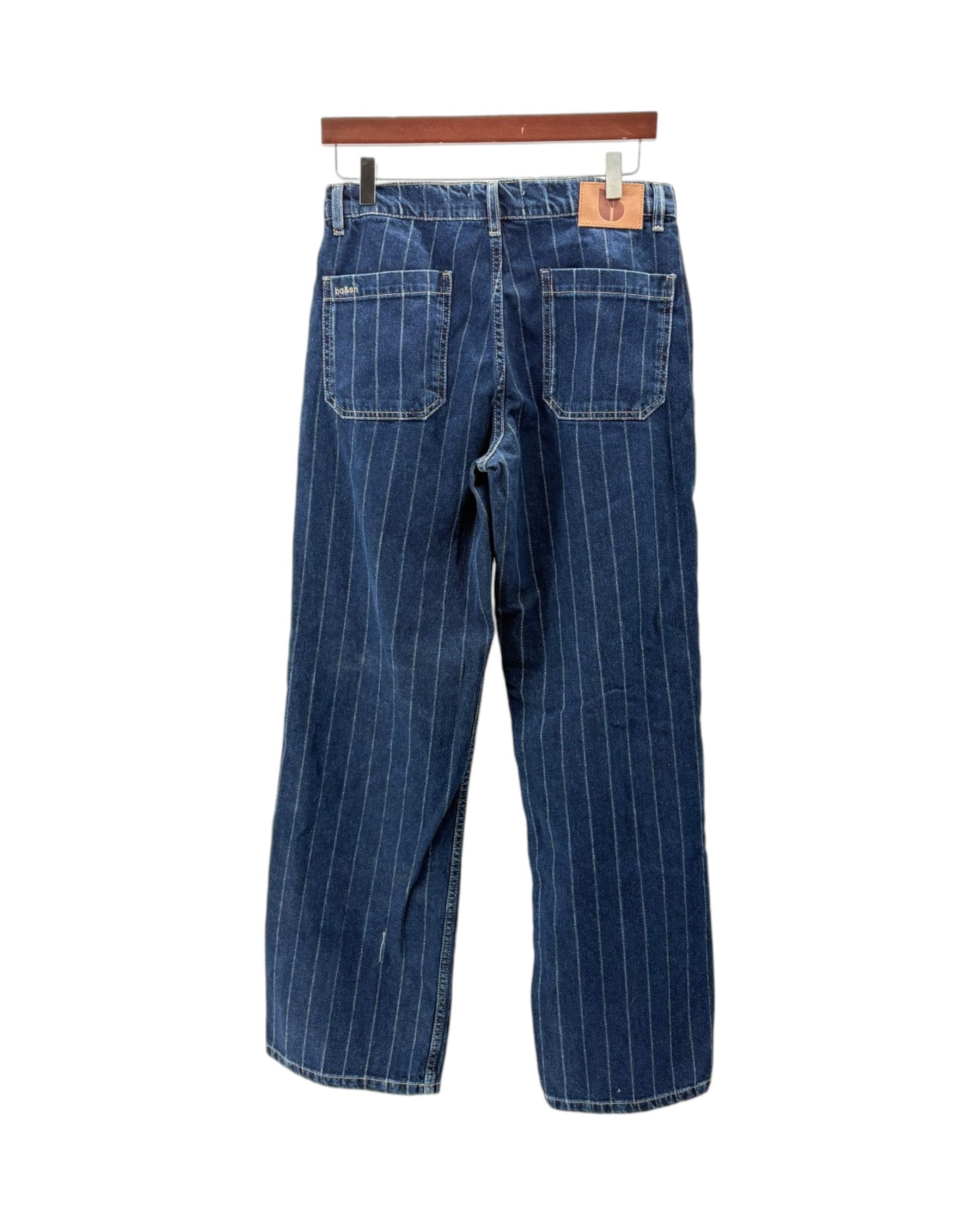 Blue pinstripe jeans on a hanger against a white background