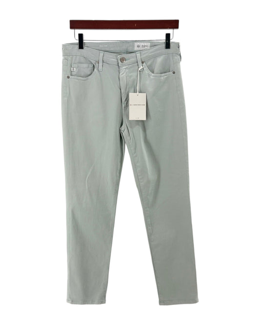 Light blue jeans with a tag on a white background
