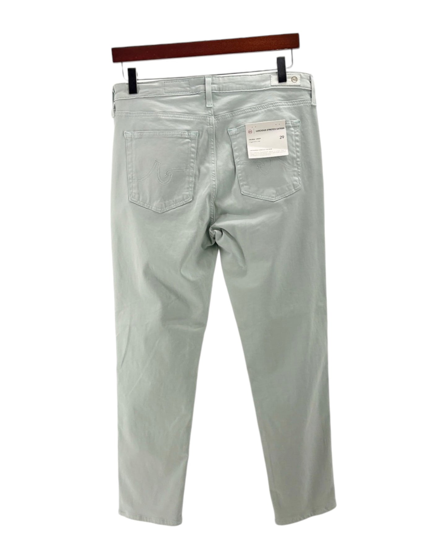 Light blue jeans on a hanger with a white background